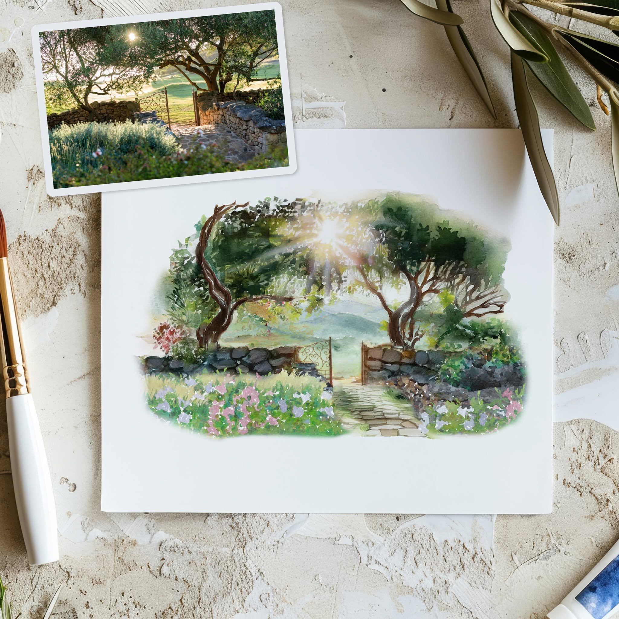 Creative process mockup showing the transformation of a wedding venue photograph into a custom hand-painted watercolor illustration. The flat lay features the original reference photo alongside the finished watercolor artwork, highlighting the bespok