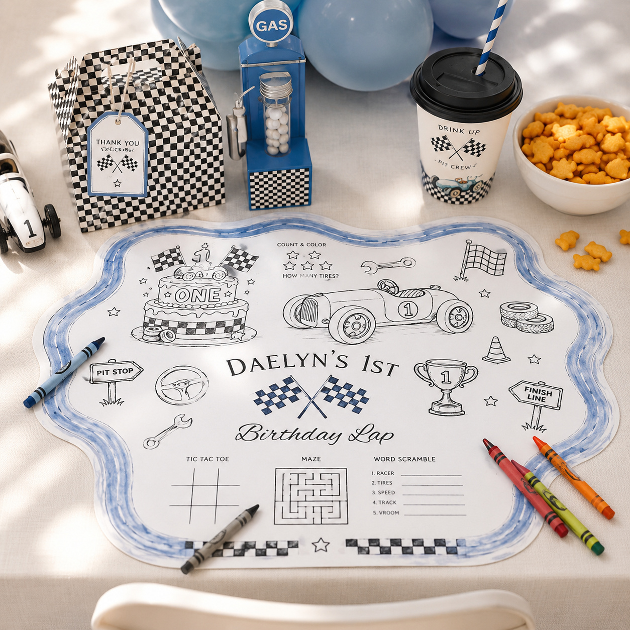 Illustrated race car themed children's activity placemat featuring coloring activities, games, crayons and party details for a first birthday celebration.