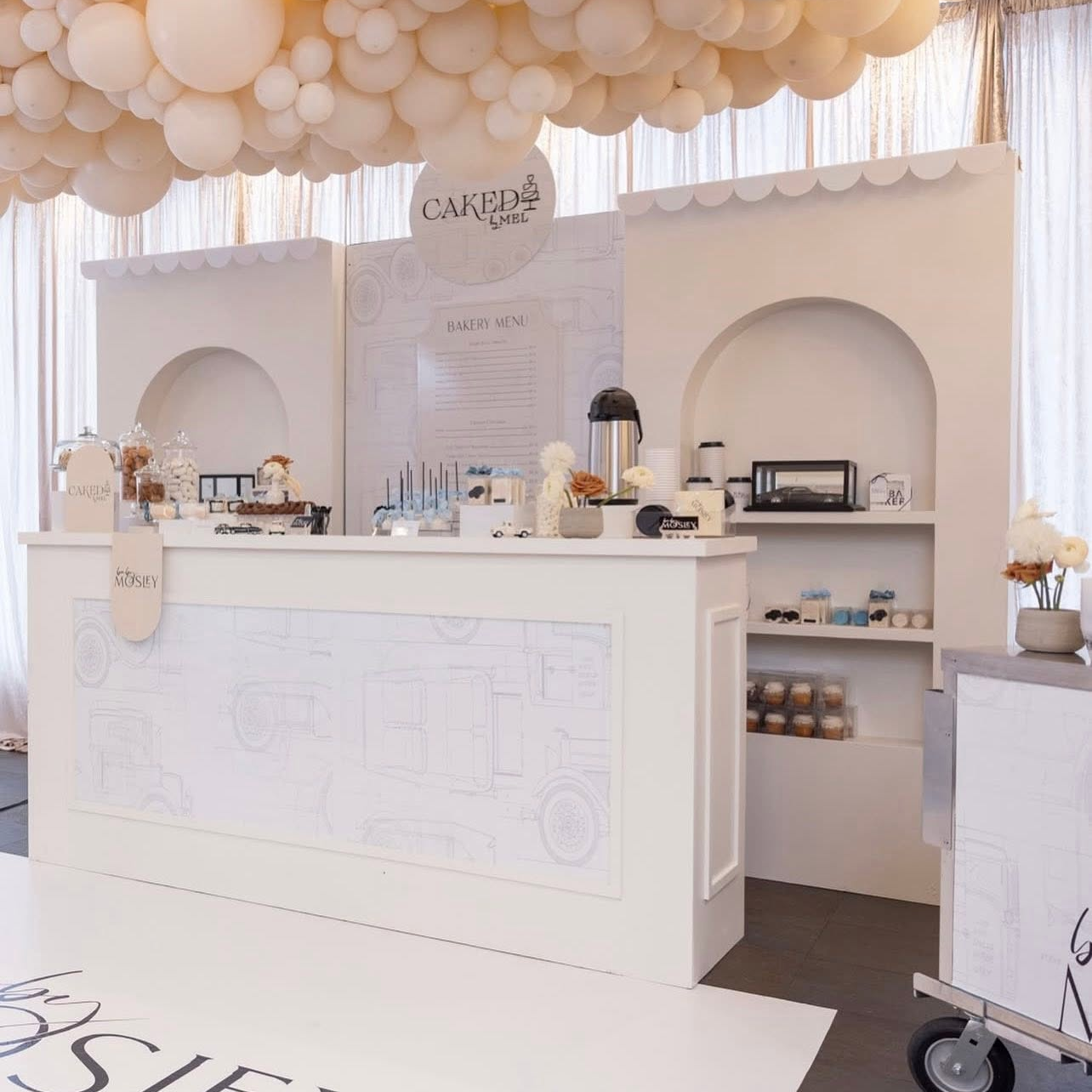 Elegant baby shower dessert display featuring custom logo design, illustrated pattern, bar wraps, floor graphics, signage, and coordinated environmental branding created for a luxury celebration.