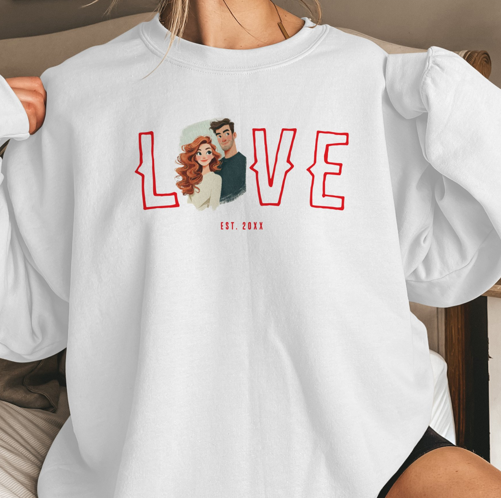 White personalized sweatshirt featuring a custom illustrated couple portrait integrated into a bold LOVE design with established date, creating a unique romantic keepsake or anniversary gift.