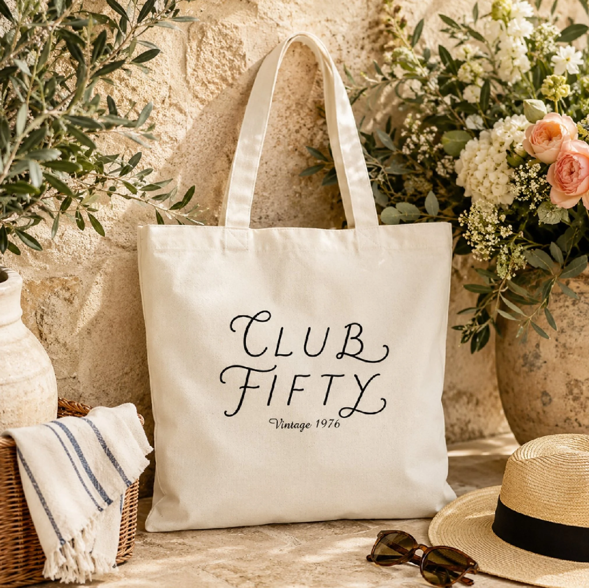 Personalized canvas tote bag featuring custom signature lettering with a vintage year design for milestone birthdays, bridal parties, and everyday gifts.