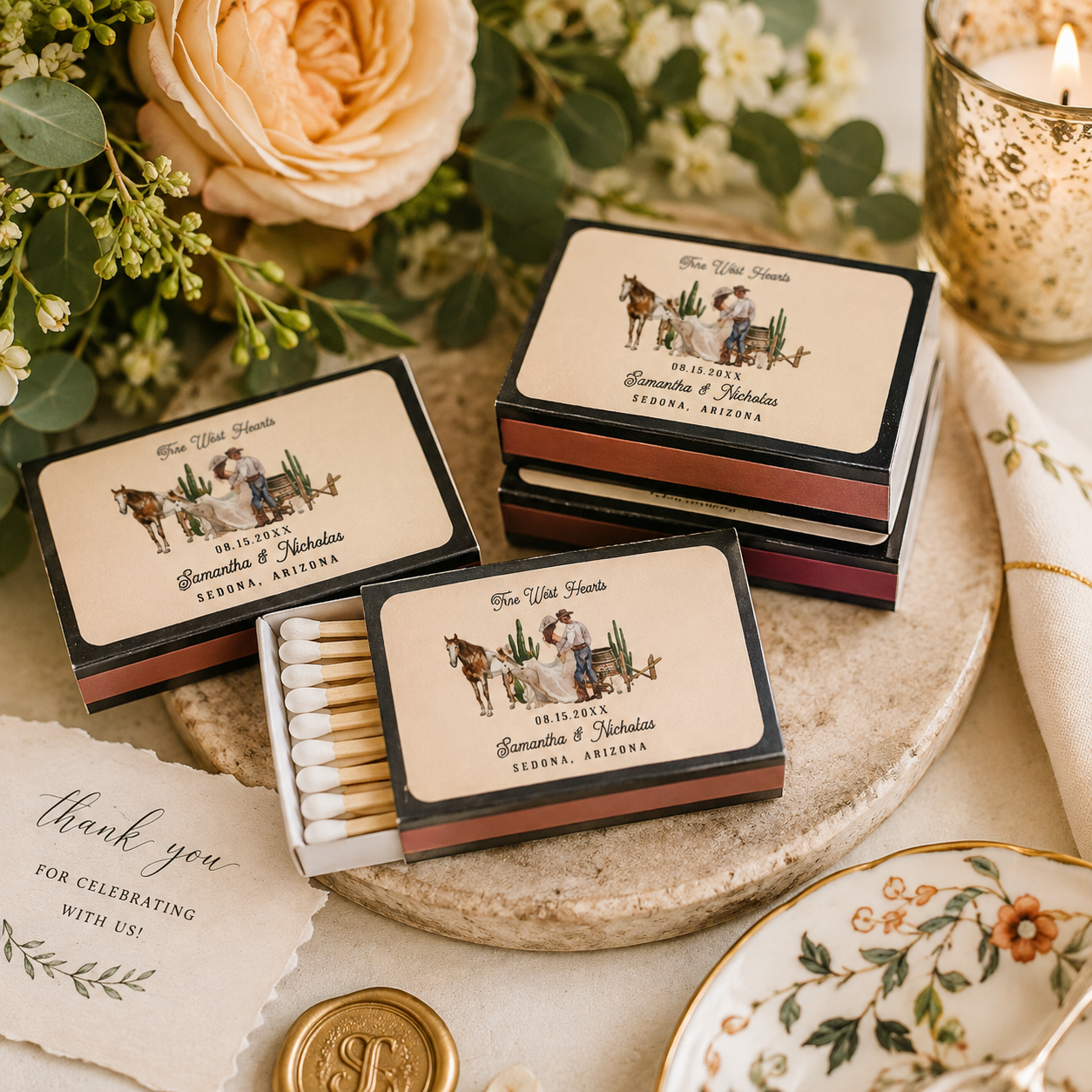 Illustrated Western wedding matchbox favors featuring custom artwork of the couple, styled with romantic florals, candlelight, and elegant reception details.