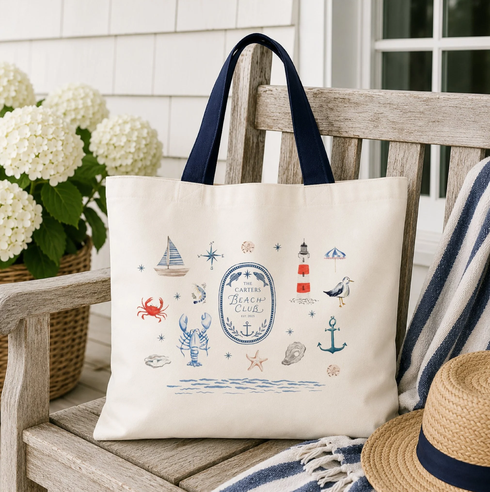 Personalized Beach Club crest tote bag featuring signature lettering and hand-painted nautical illustrations including a lighthouse, sailboat, lobster, anchor, seashells, and coastal icons.