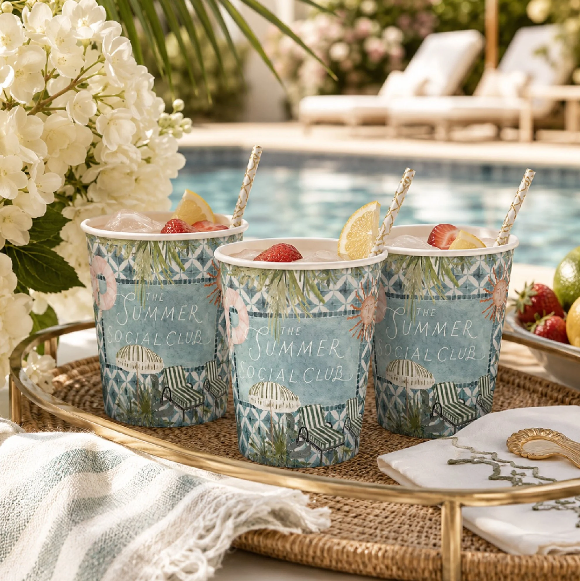 Custom paper cups featuring signature lettering and hand-painted summer illustrations for a pool party, garden party, or outdoor celebration.