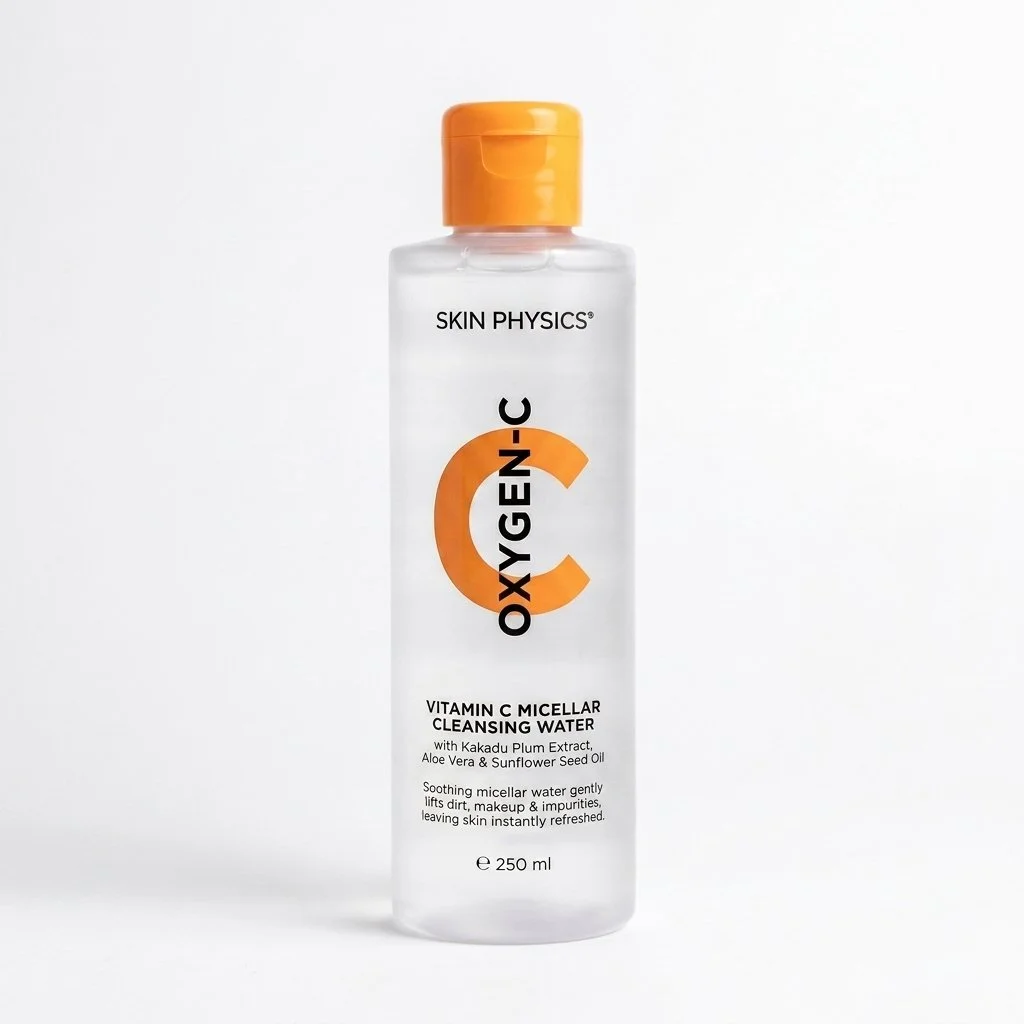 A clear bottle of Skin Physics Vitamin C Micellar Cleansing Water with an orange flip-top cap.