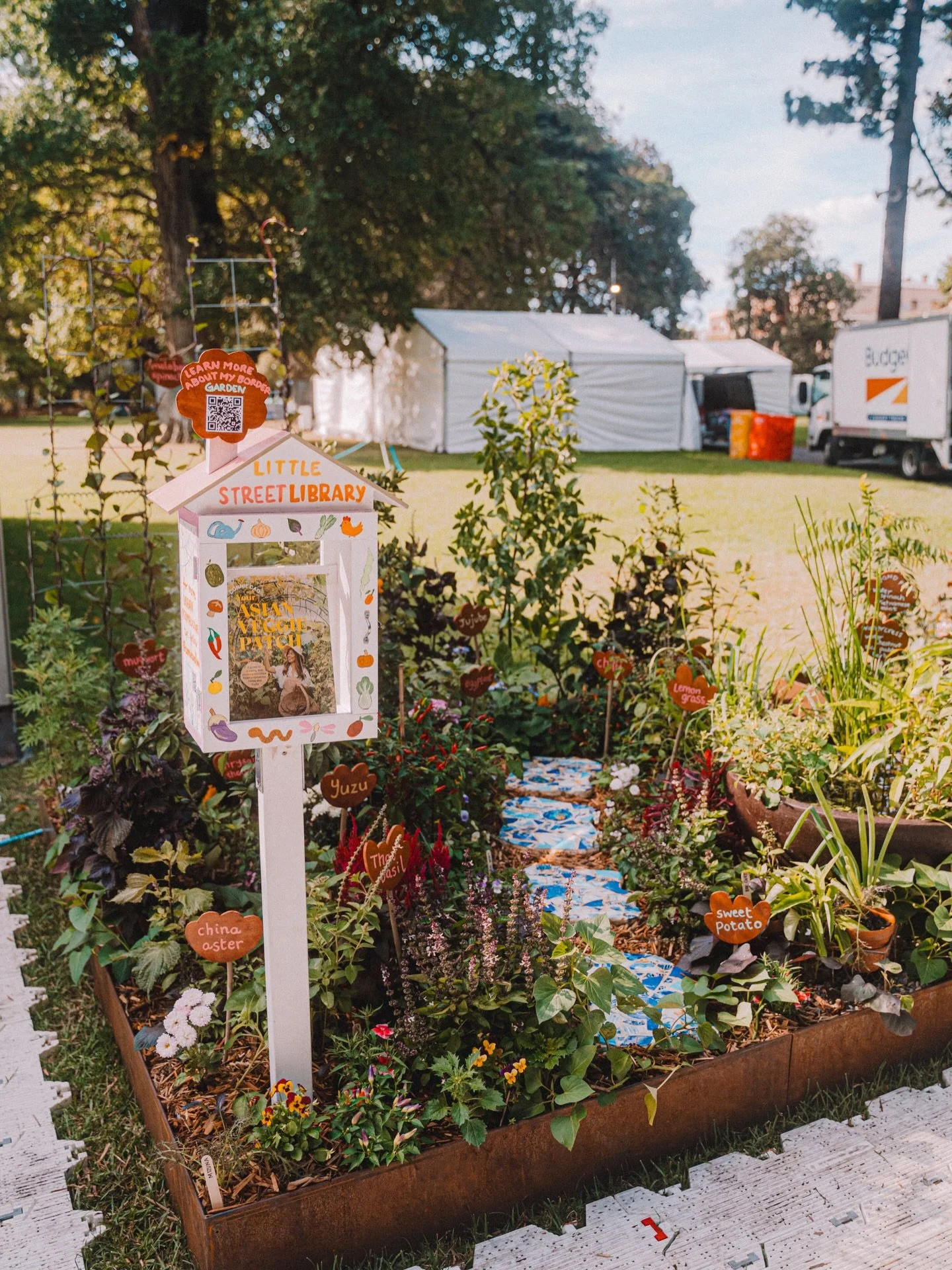 Welcome to Your Asian Veggie Patch, a celebration and connection to culture, with over 30+ different food plants in a 2.4m2 space. Permaculturally designed, with upcycled plant labels, a worm tower (composting for every space), street library &amp; a