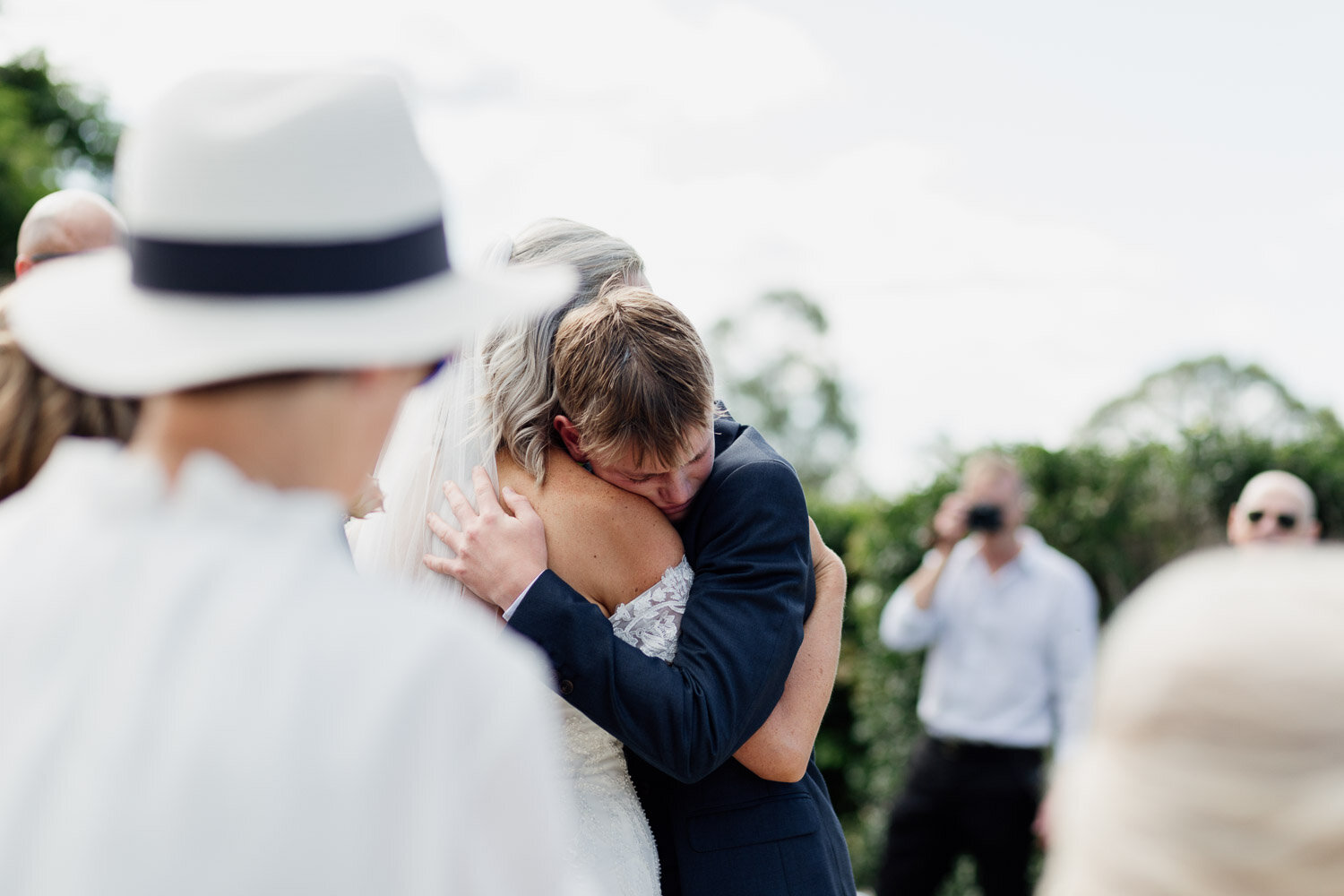 Bride hugging groomsmen