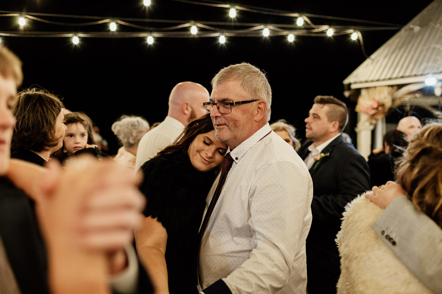 Father and daughter hug at wedding