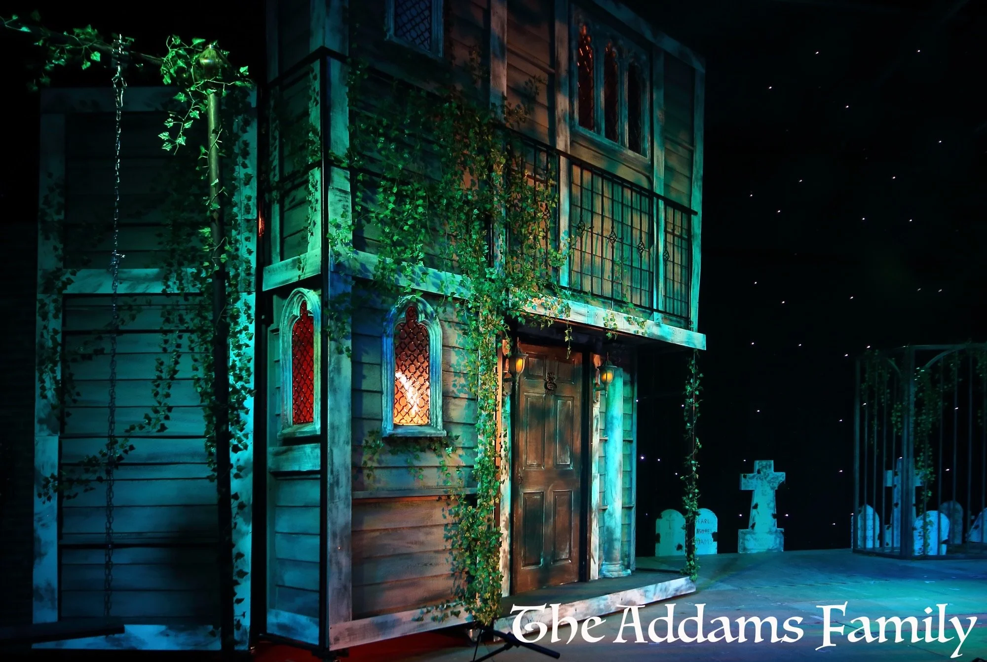 Addams Family - set hire - uk set and prop hire - packages - torture contraction - gates - great hall - staircases- torture chair - exterior - gravestones - tables