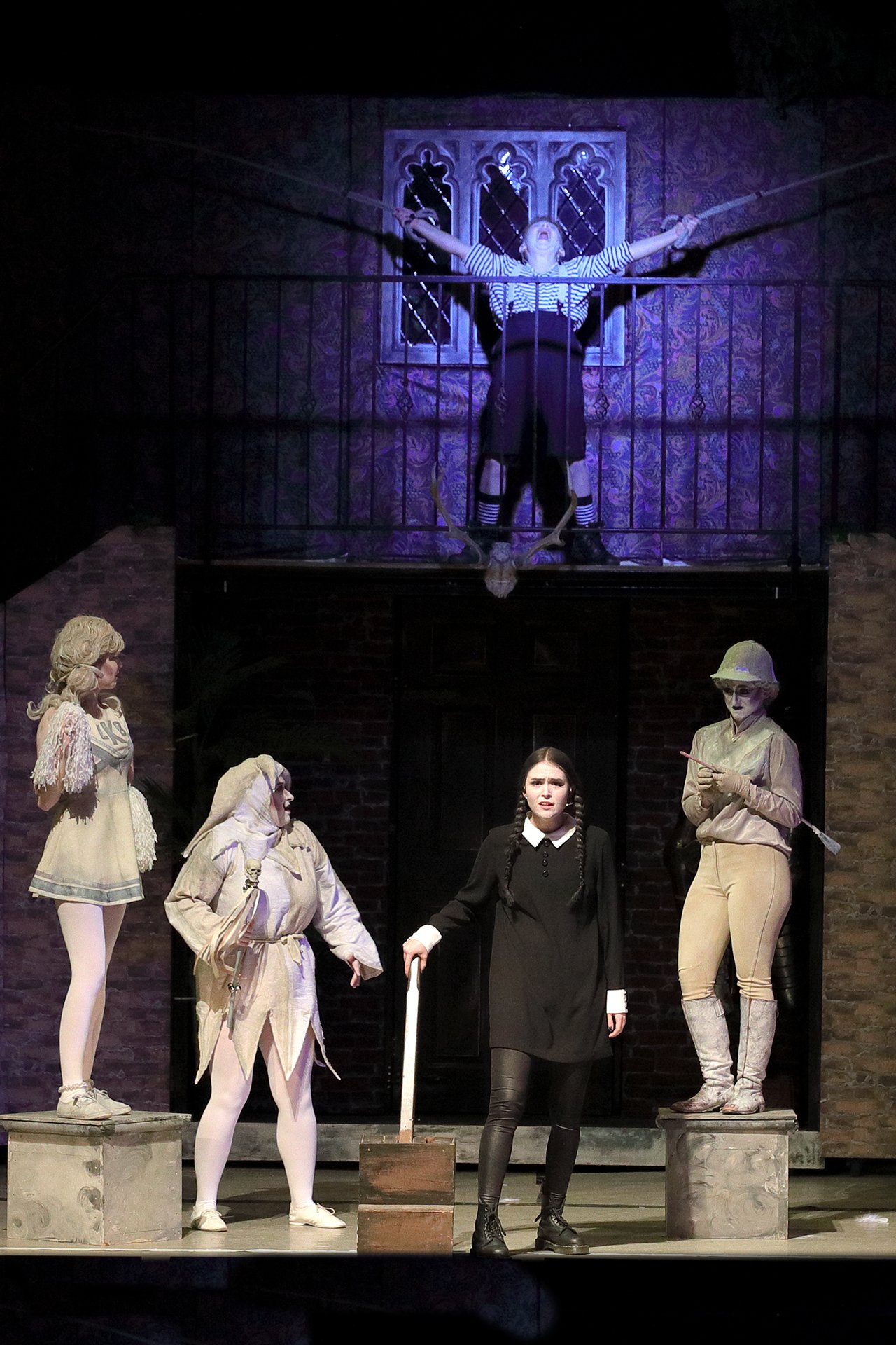 Addams Family - set hire - uk set and prop hire - packages - torture contraction - gates - great hall - staircases- torture chair - exterior - gravestones - tables