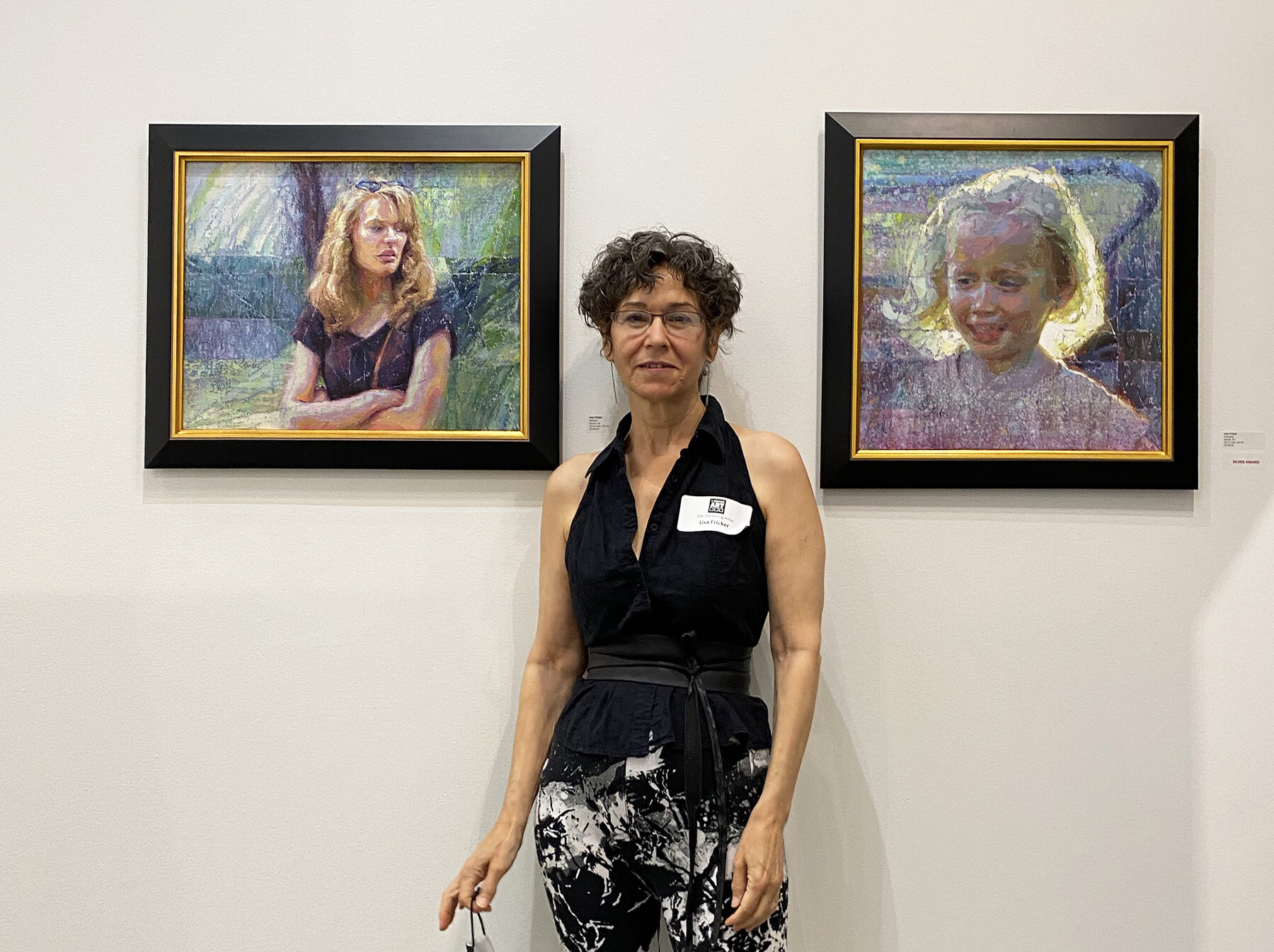   Lisa Fricker  with her paintings “Attitude” and “Unbridled” 
