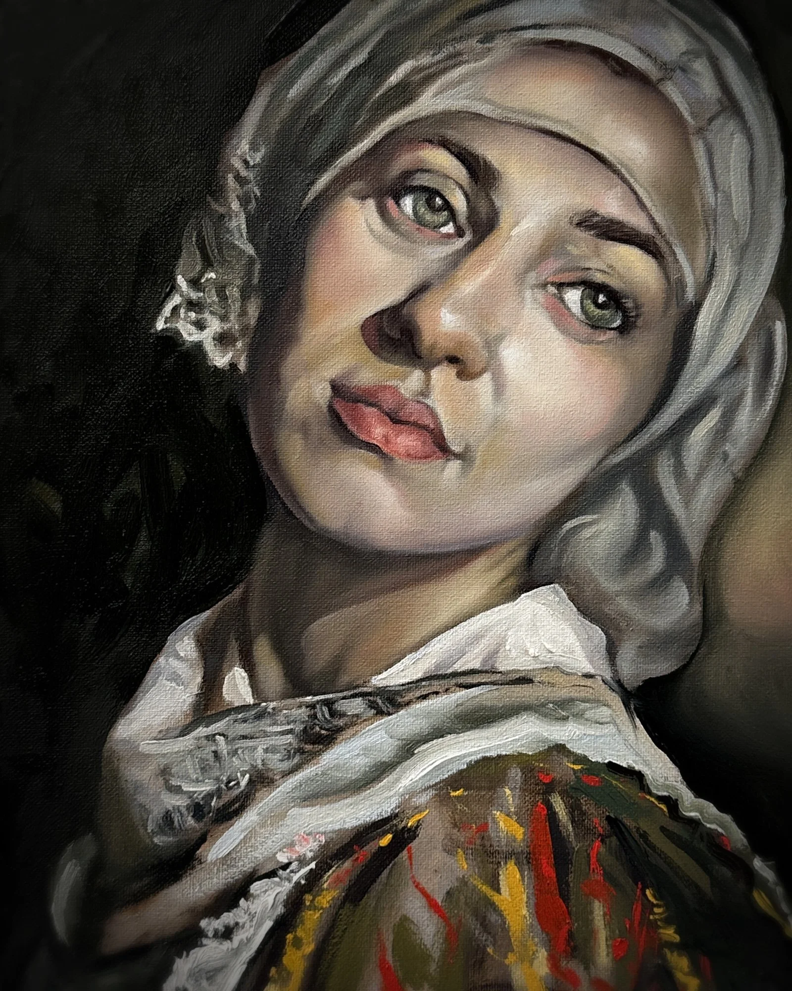 Close-up of a young woman with fair skin, grayish hair, and green eyes, wearing a white headscarf and a colorful garment.
