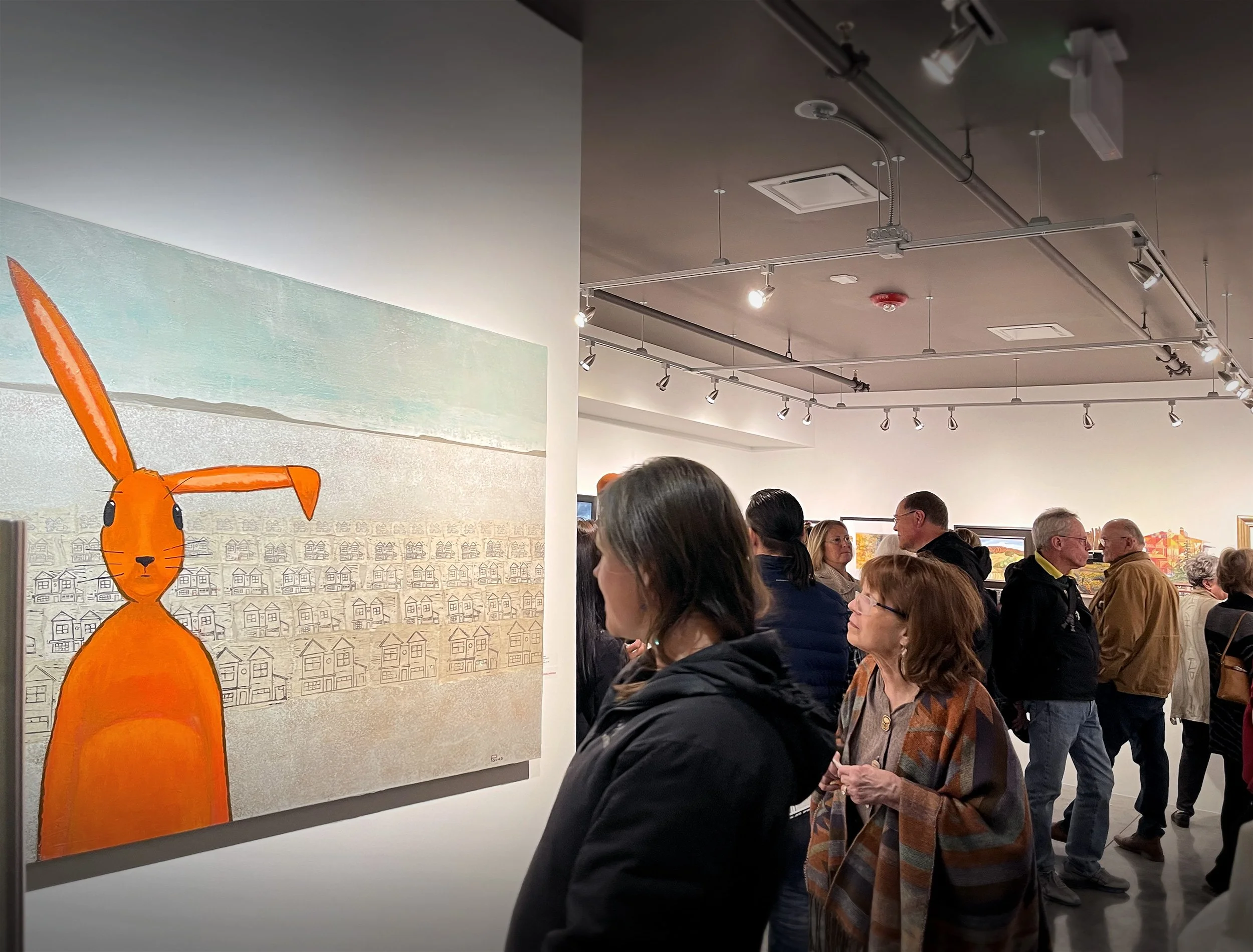 Visitors enjoying art during an Opening Night Receptions at 3 Square Art