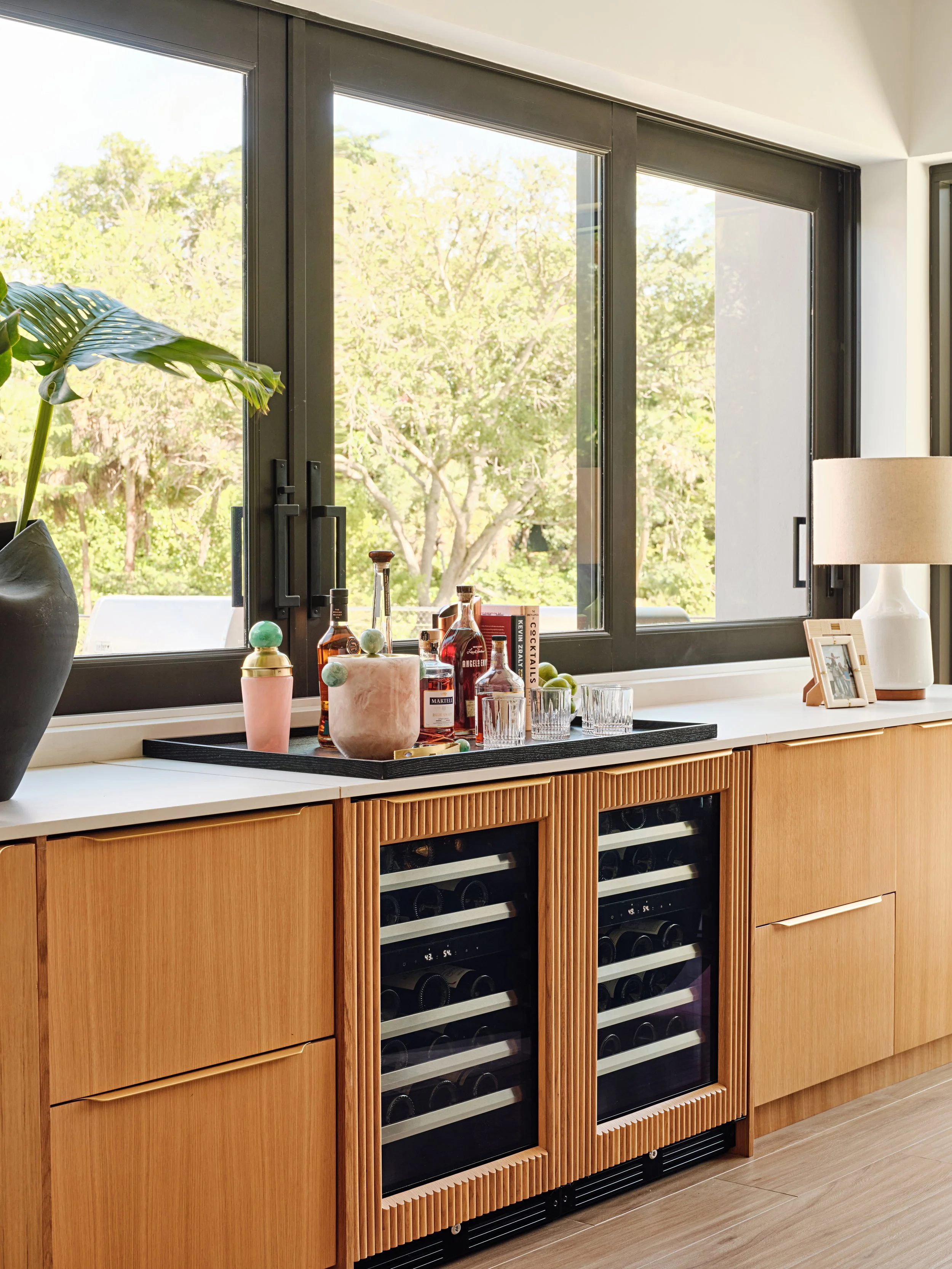 Custom built-in bar cabinetry with panel ready wine fridge, icemaker, and beverage coolers in Kendall FL, interior design by Concept 2 Design
