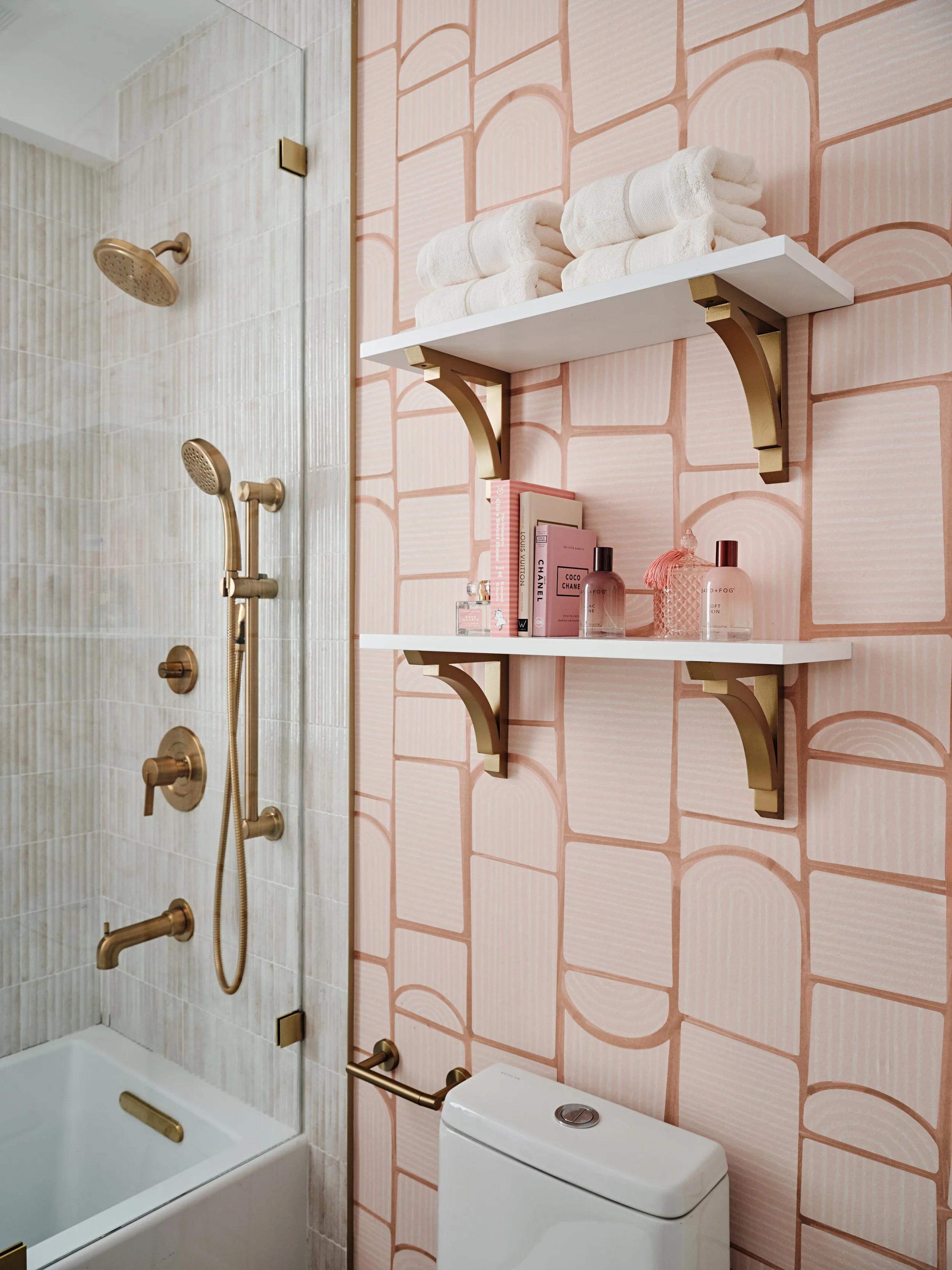 Brass and pink details in bathroom. Brass shower fixtures. Interior design by Concept 2 Design.