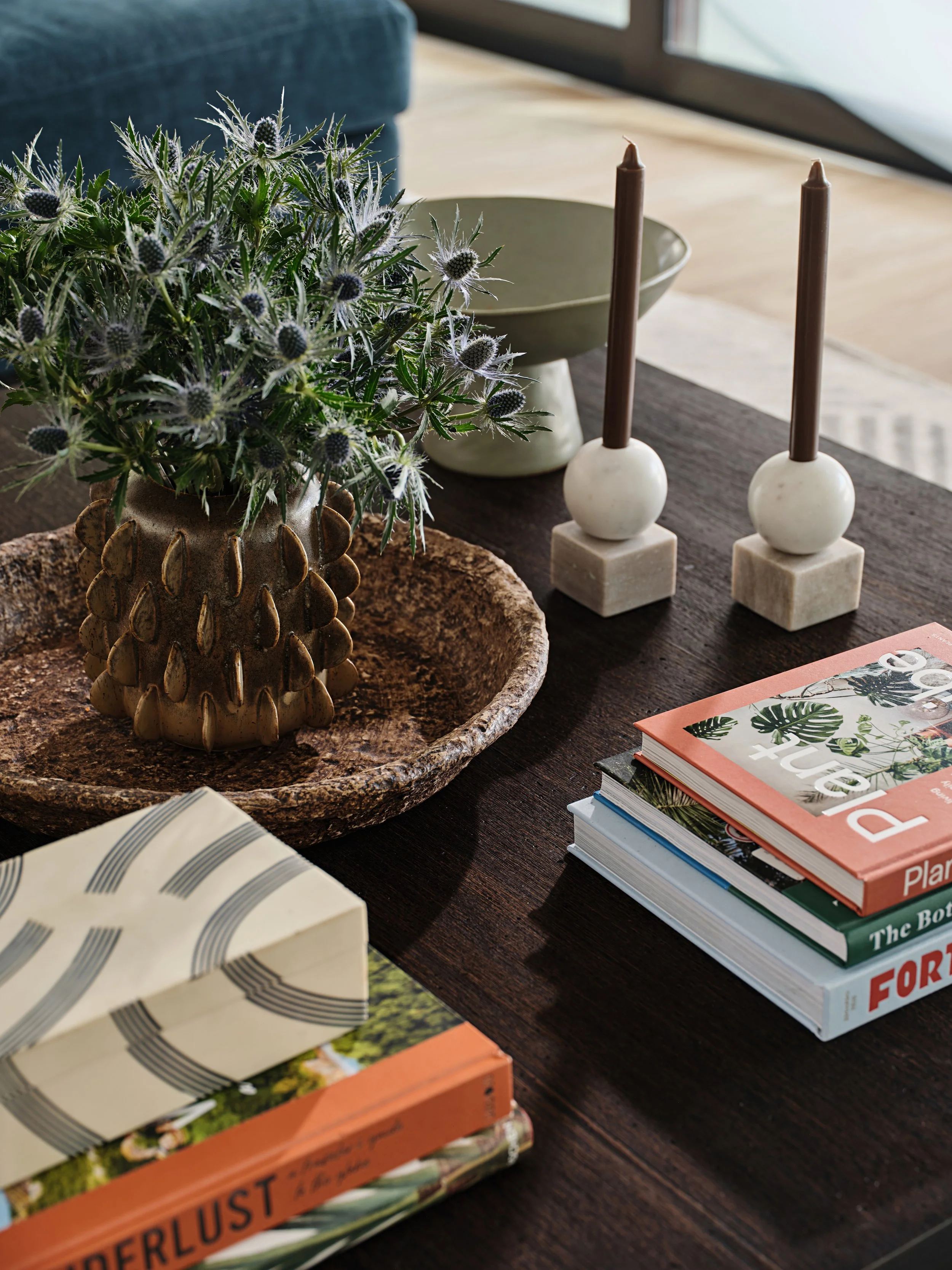 Coffee table styling. Dark wood coffee table with stacks of blooks in a residential home in South Florida. Interior design by Concept 2 Design.