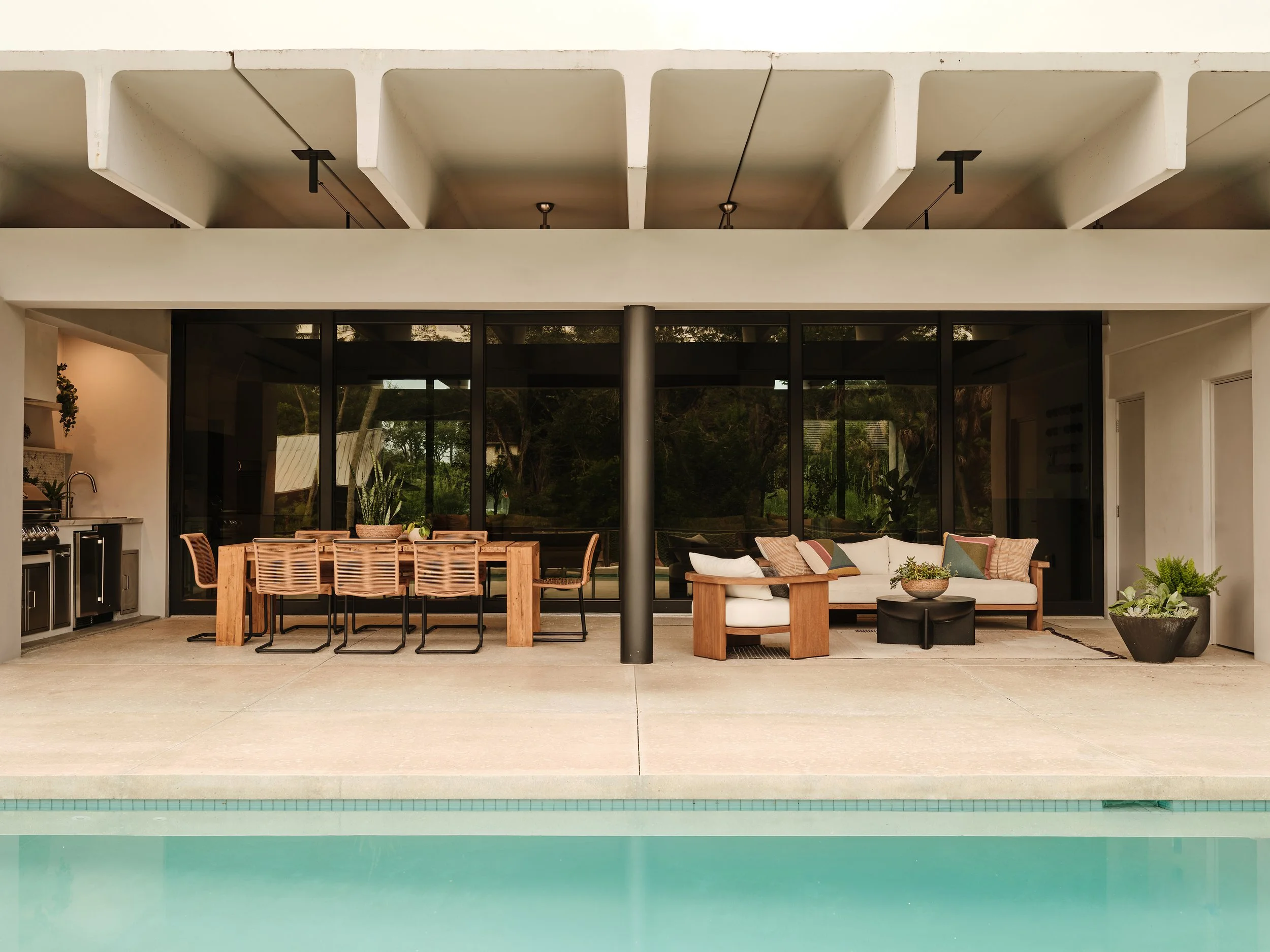 Covered outdoor dining and lounge area overlooking the pool in South Florida.