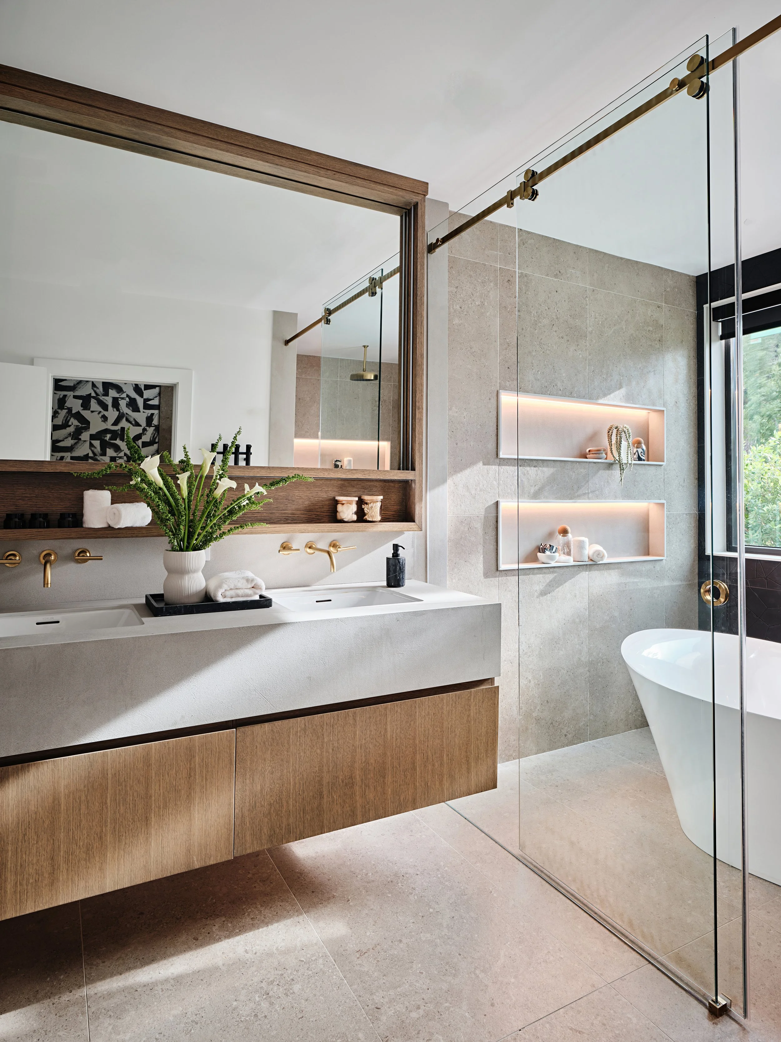 Contemporary double sink wall hung custom bathroom vanity cabinet. LED lighting in shower niches. Interior design by Concept 2 Design. 