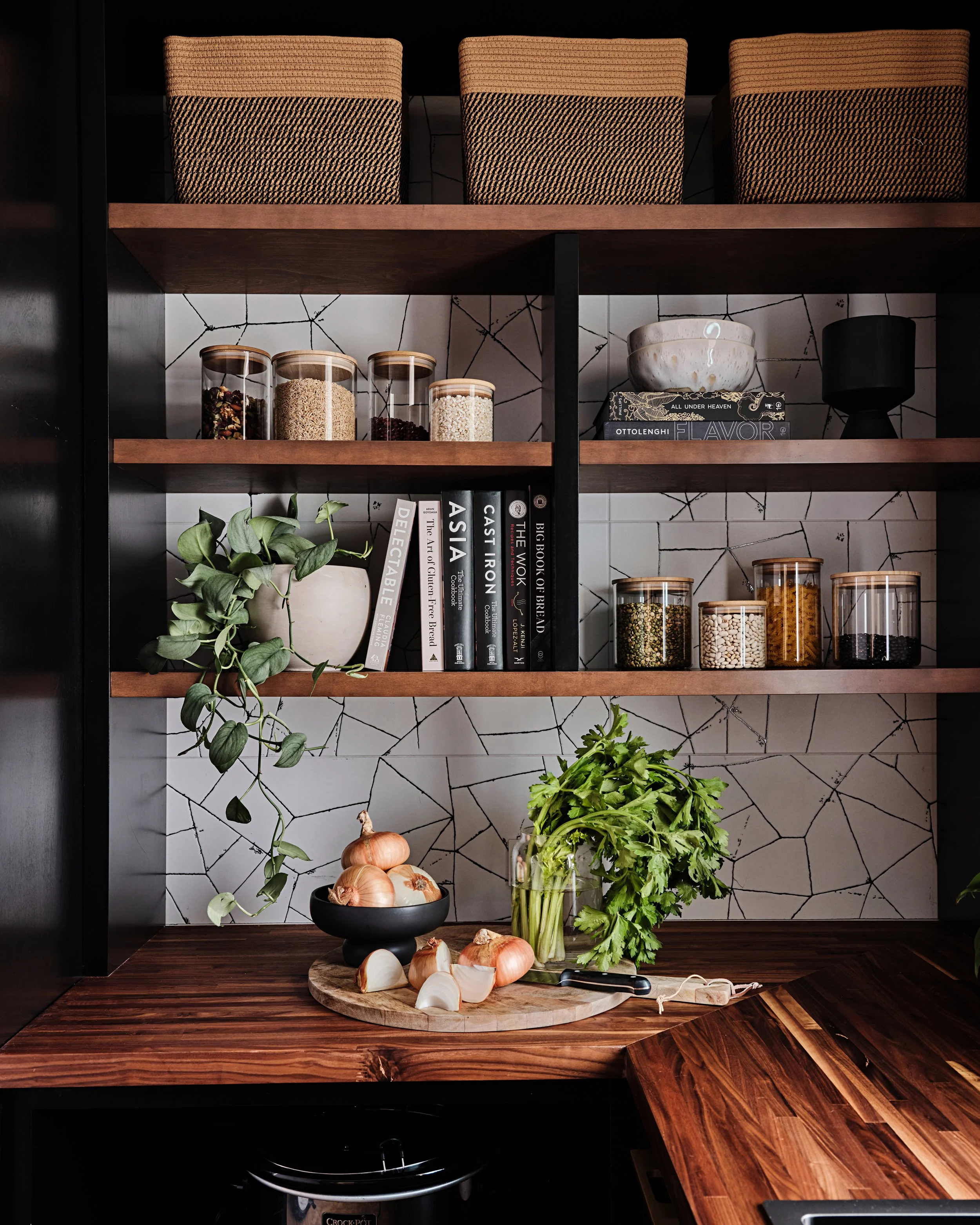 Black and white tile backsplash in butler's pantry. Black and oak wood custom cabinets in a residential home in Miami, Fl. Interior design by Concept 2 Design. 