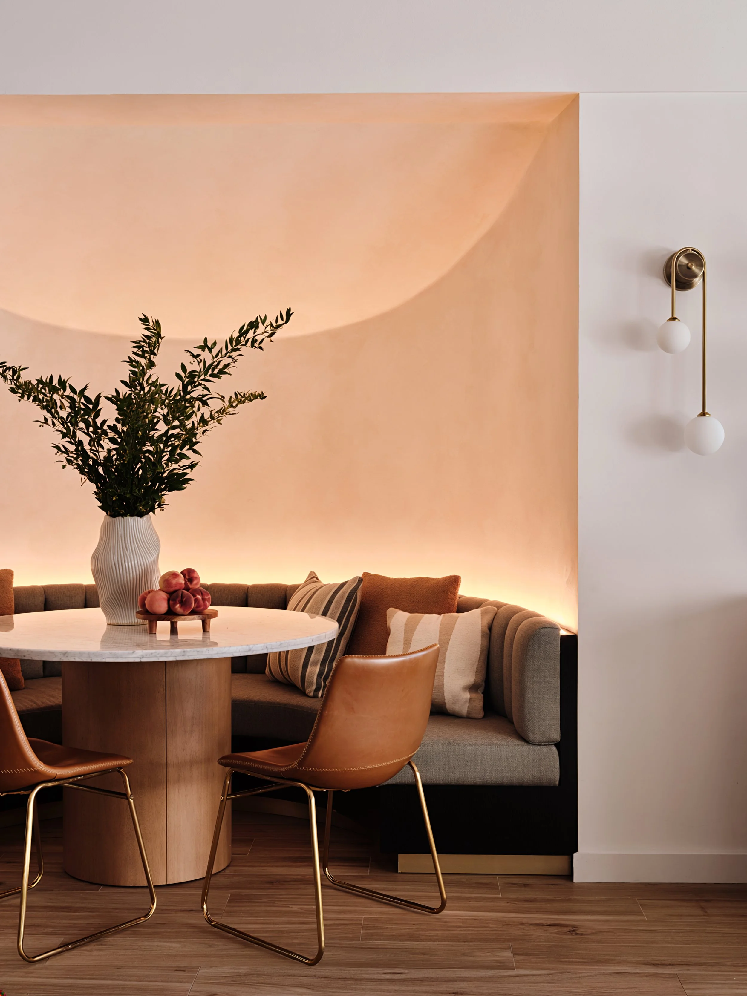 Detail of a round breakfast nook with limewash walls and LED lighting in a Kendall new-construction home. Interior design by Concept 2 Design