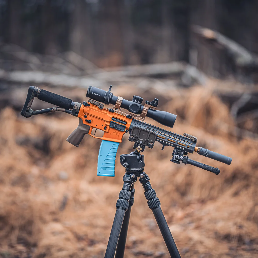 Orange-receiver rifle on a tripod in the field