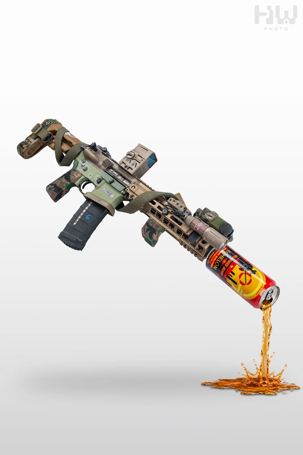 Camouflaged rifle suspended above a pouring energy drink