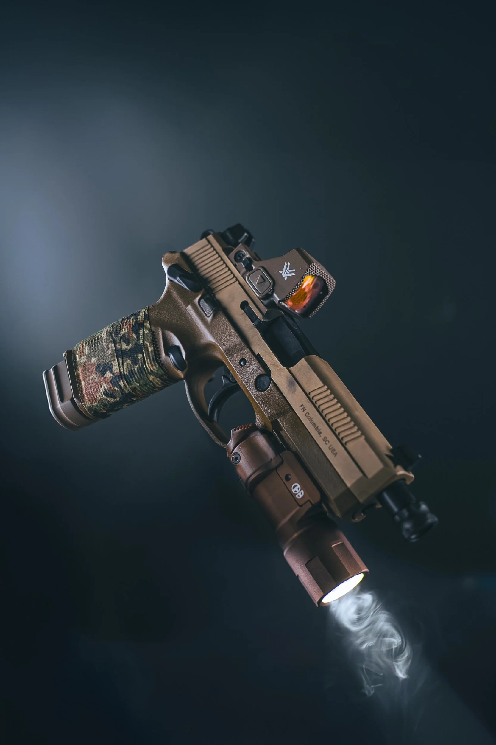 FDE pistol with weapon light and drifting smoke, photographed by Justin Holt