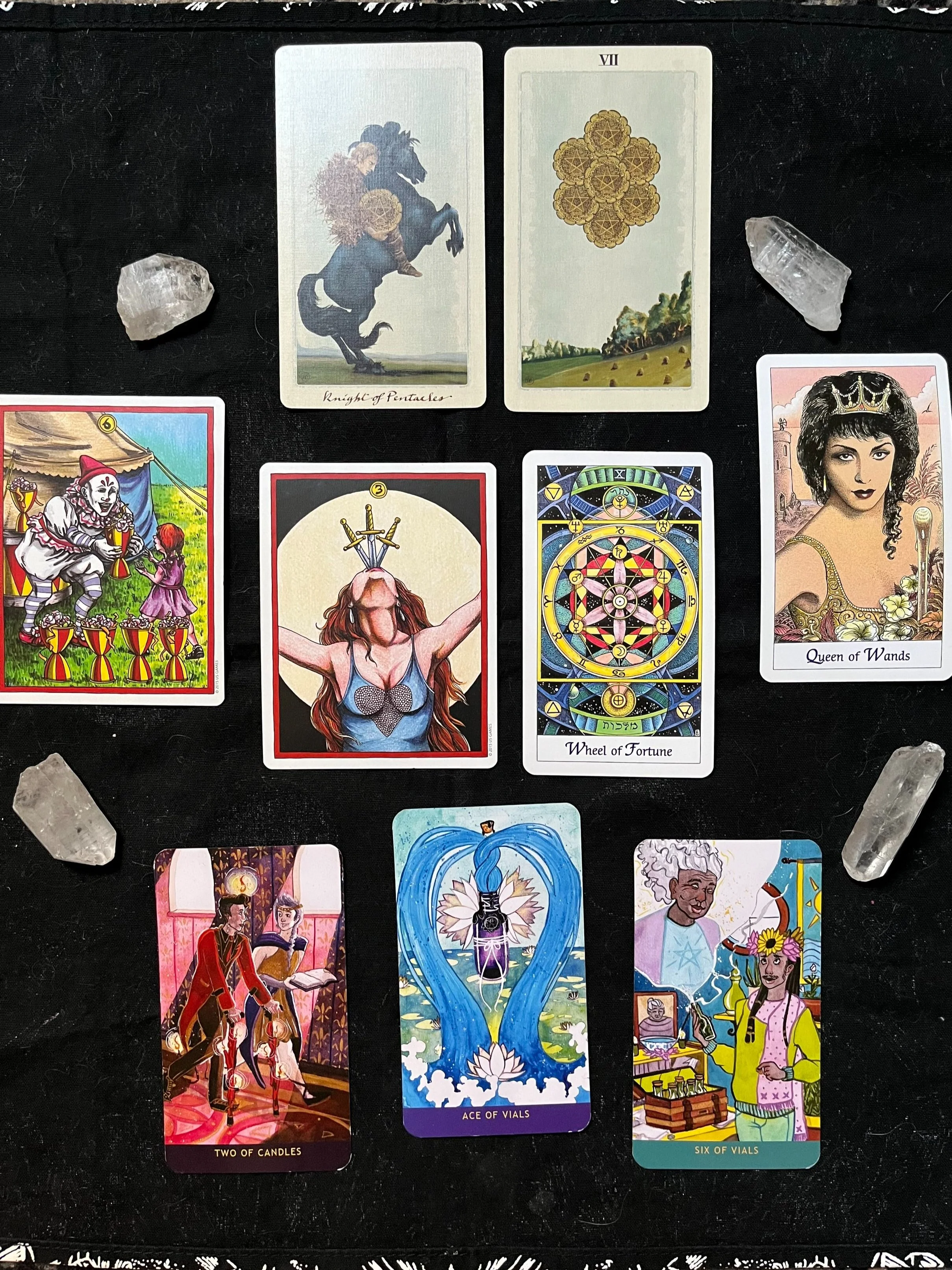 A Tarot spread regarding the energies of March 2022 for the collective consciousness. The cards are surrounded by four quartz crystal points.