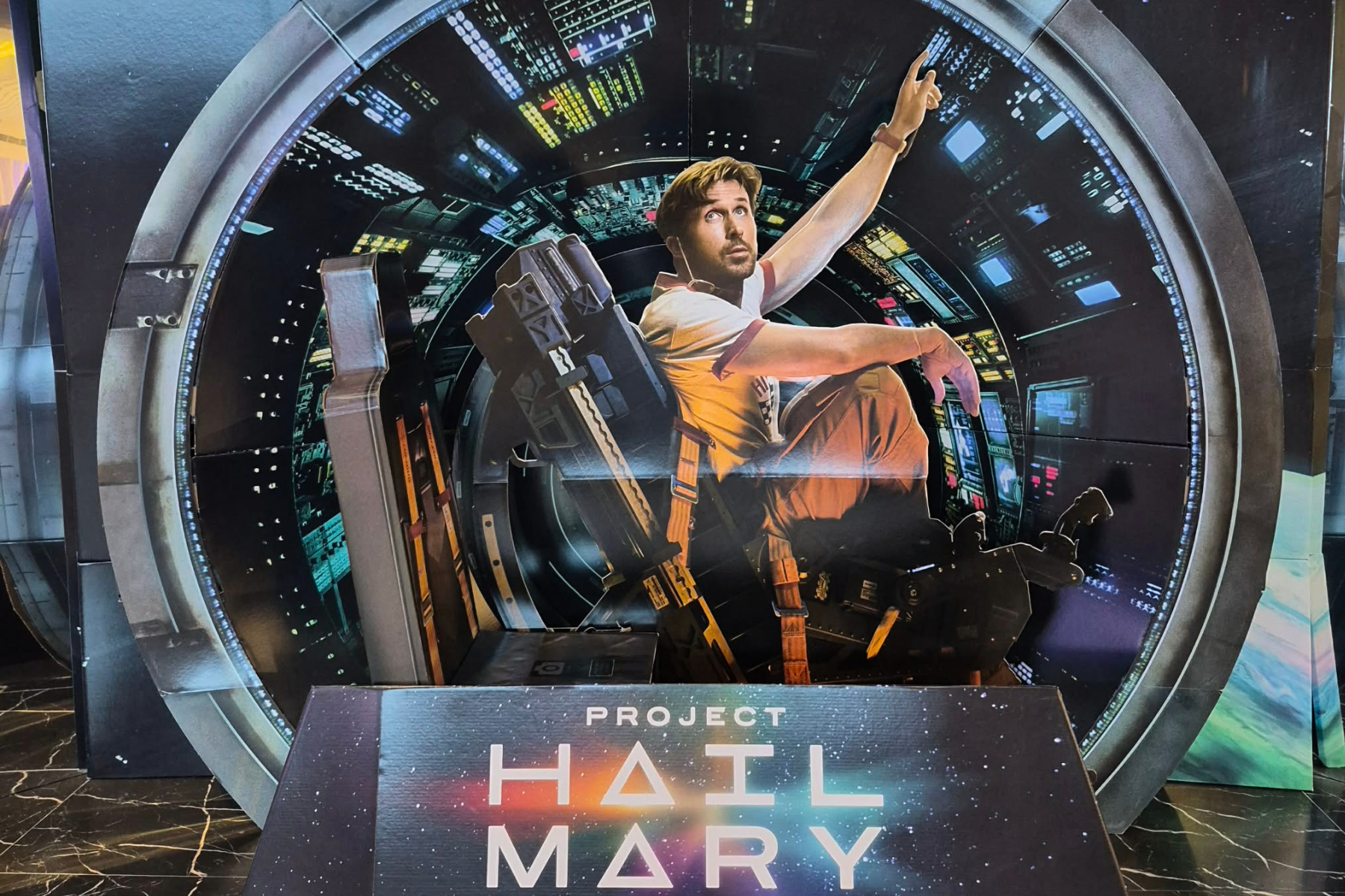 Project Hail Mary cinema display featuring Ryan Gosling as Ryland Grace in the science fiction film adaptation.
