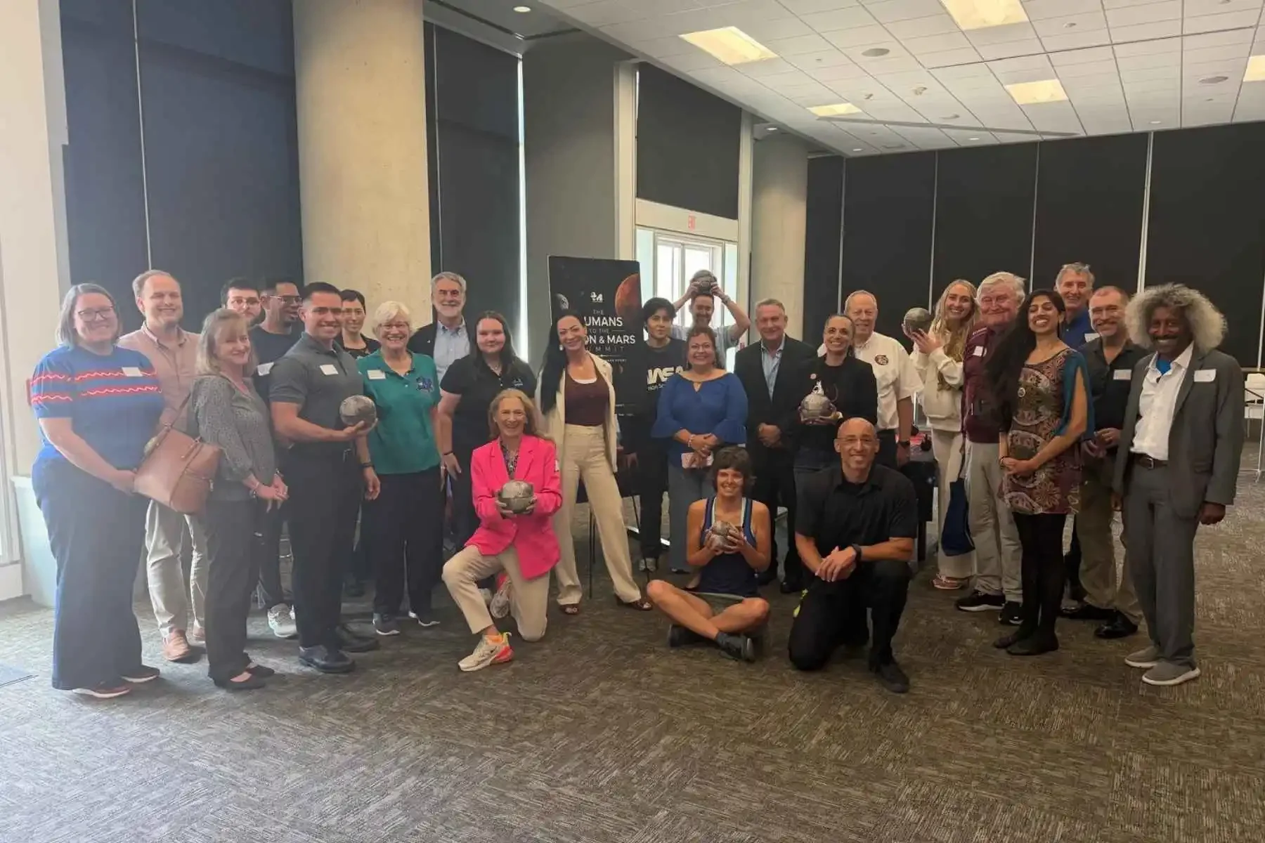 Group photo of Feeding the Future workshop participants standing together in a conference room, representing space agencies, private companies, academia, and the food sector.