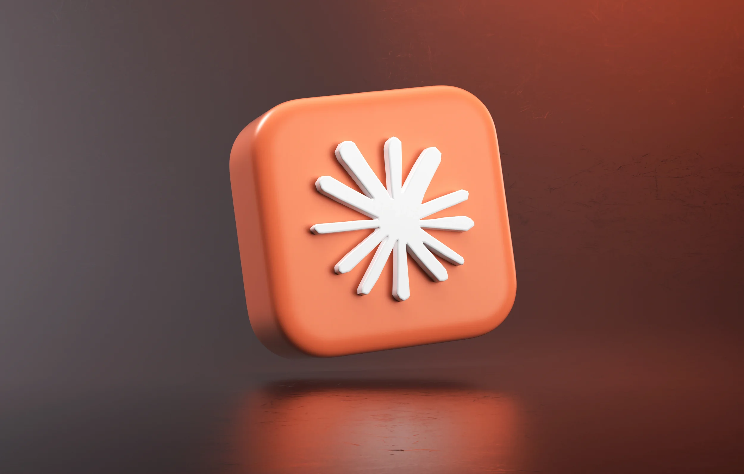 A rounded 3D square orange app tile featuring the white starburst emblem of Claude AI by Anthropic.