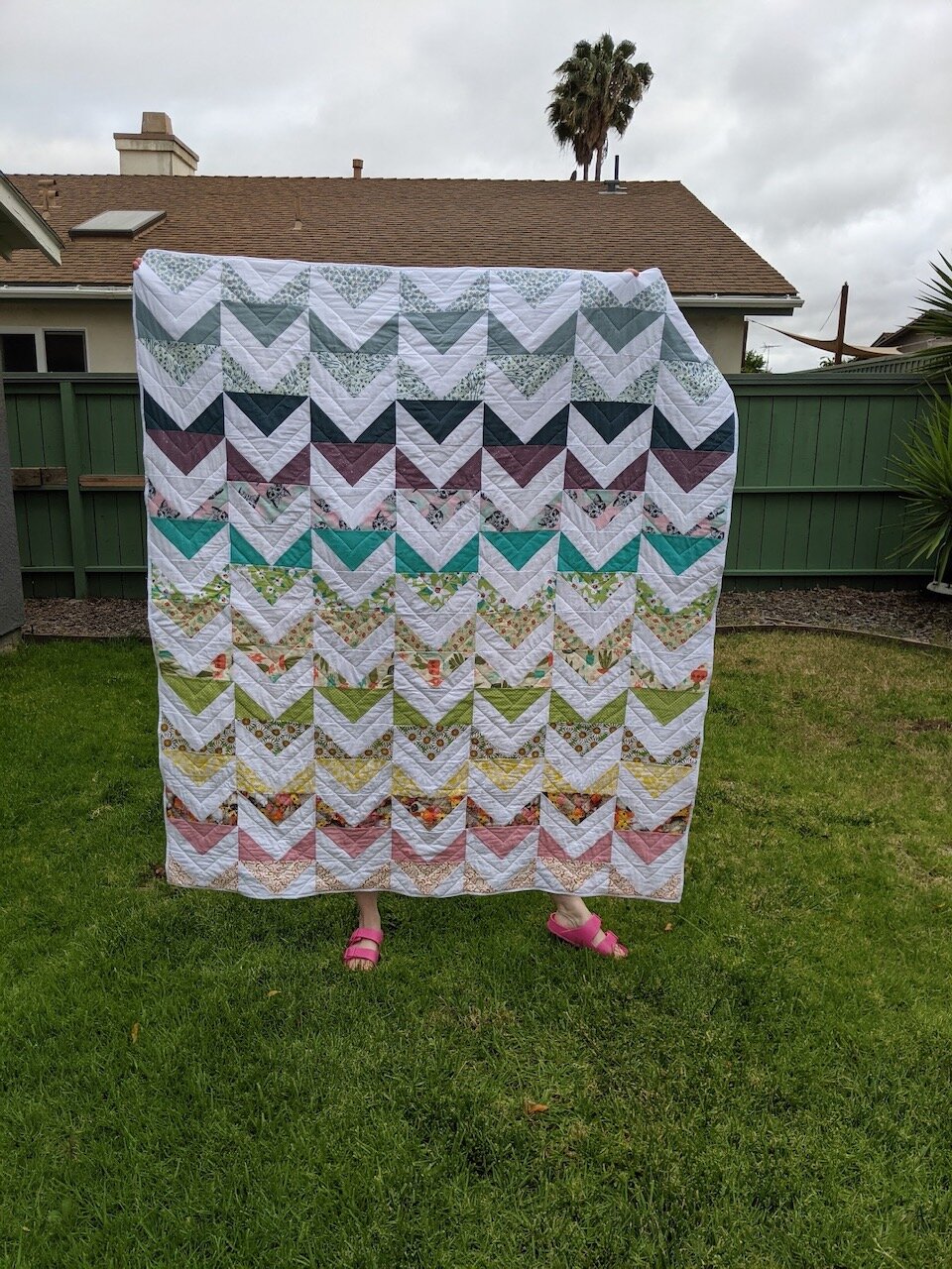Paige used a solid white background for her quilt, which really makes the colors and prints pop! I love the chevron quilting design she added to echo the shapes of the pattern. And this is such a beautiful spring photo! (Paige has a private IG page.)