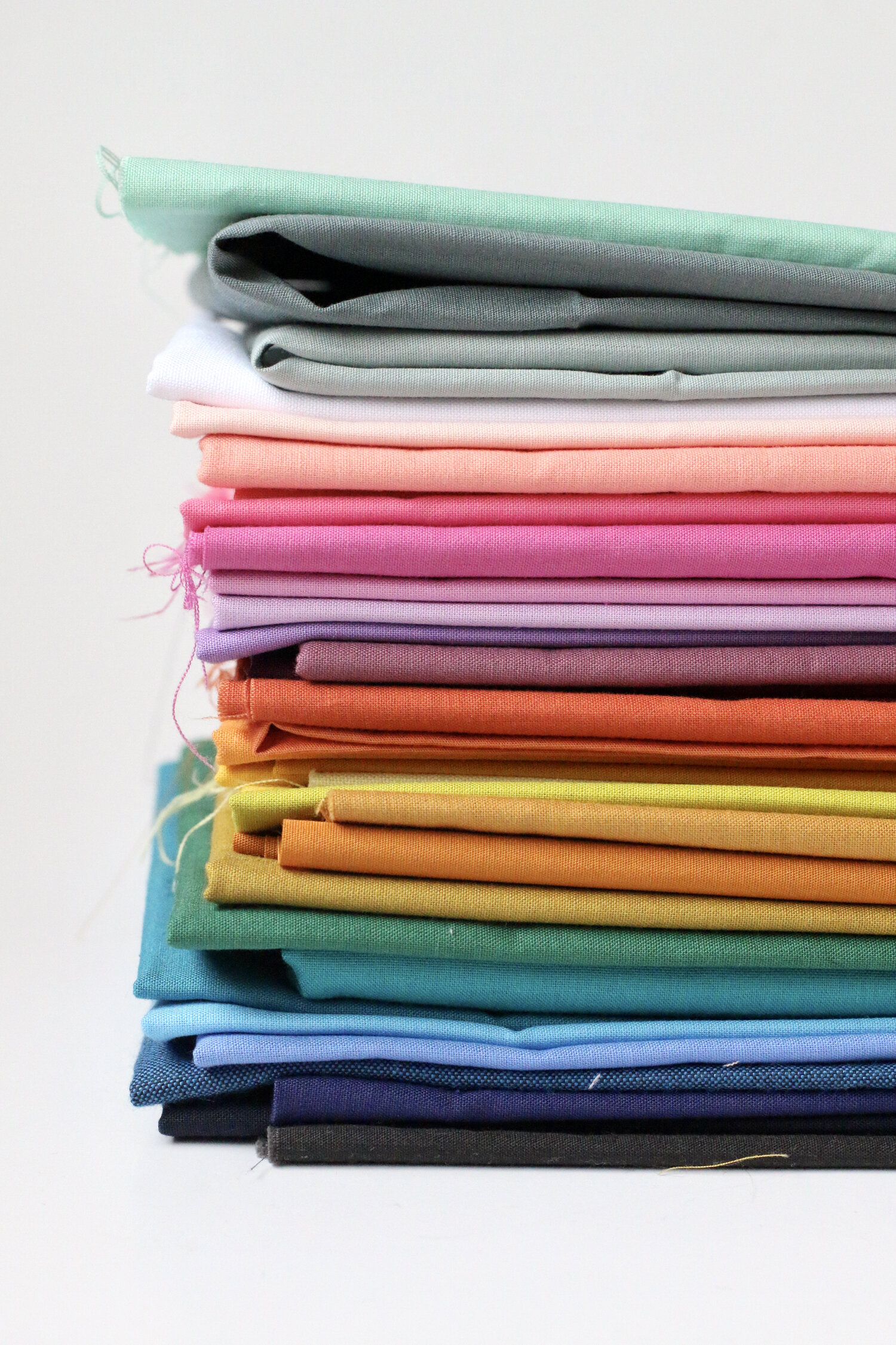 My solid fabrics in color order.