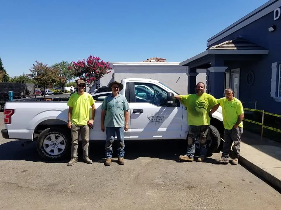 Landscaping Yuba City CA team standing beside a company work truck before a landscape installation project.
