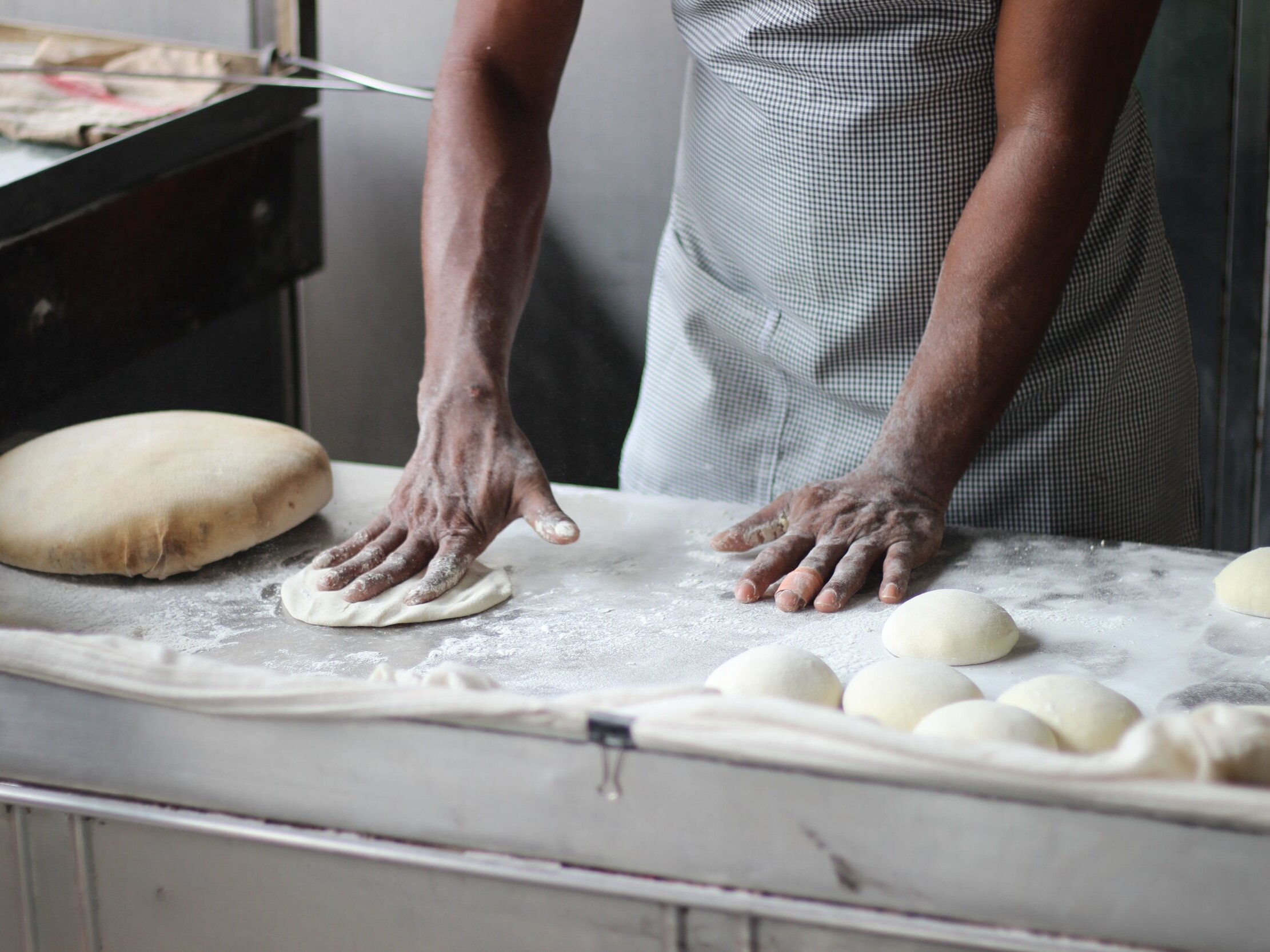 man-preparing-dough-for-bread-3218467.jpg