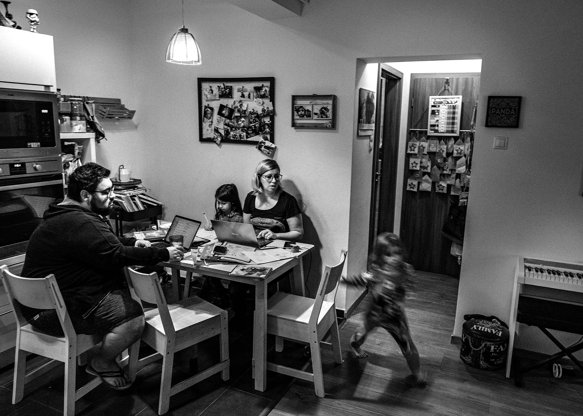  Zsani and Norbi around the kitchen table learn and work together with the twins in their apartment. Molli's classmate was tested positively with coronavirus so the whole class were quarantined. 