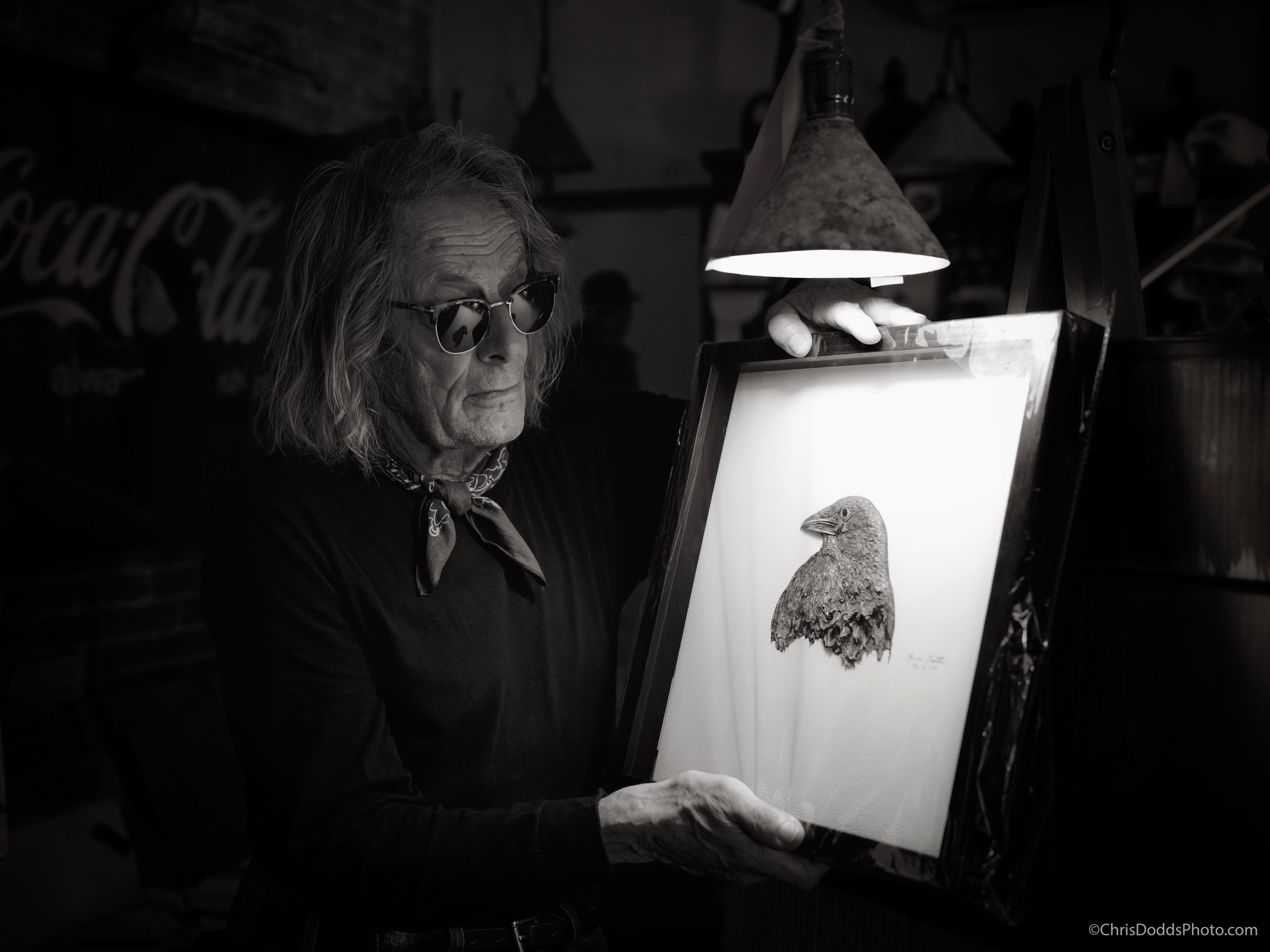 Black and white portrait of New Brunswick artist Steven Smith holding one of his intricate crow artworks inside Crocker Hill in St. Andrews by-the-Sea, photographed using available light with a Leica Q3 43.