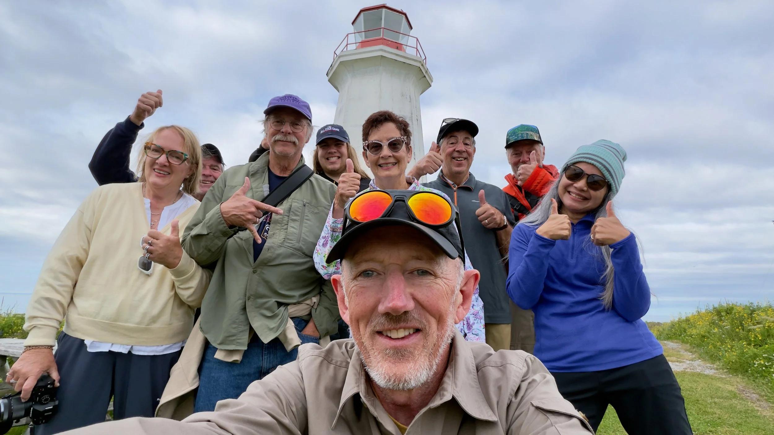 Group 1: Christopher Dodds with participants from the 2026 Puffins Galore photography workshop on Île aux Perroquets, Quebec.