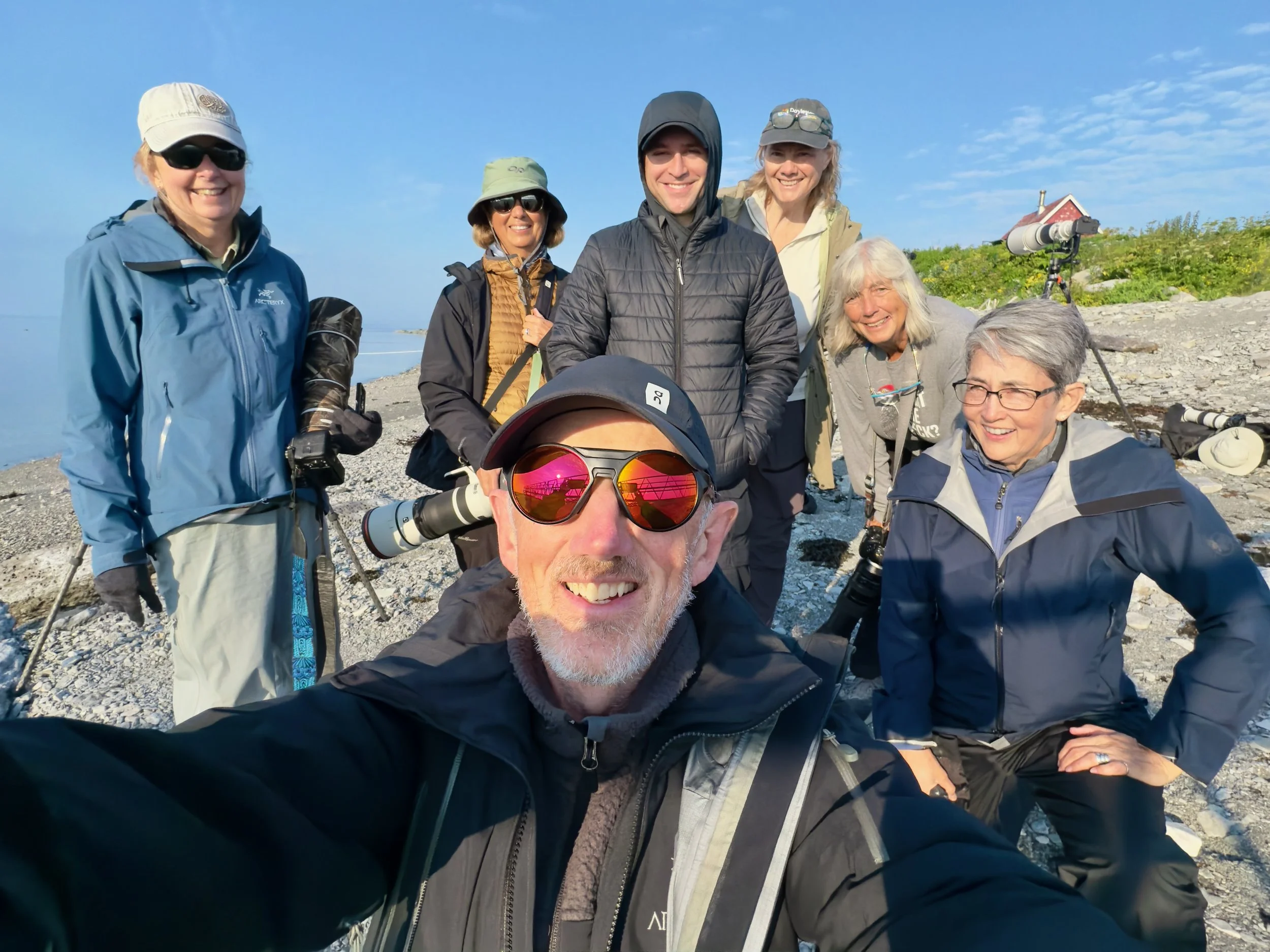 Group 3: Wildlife photographers with Christopher Dodds on Île aux Perroquets during the 2026 Deluxe Puffins Galore photography workshop.