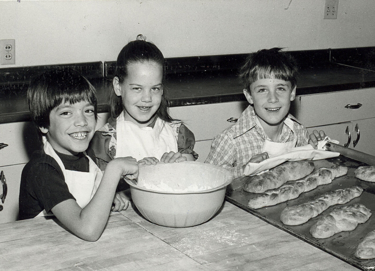 Levi Epicar, Gail Gregos, and Michael Hoffer, second graders at Temple Beth Israel Day School, learn to baked their own challahs.