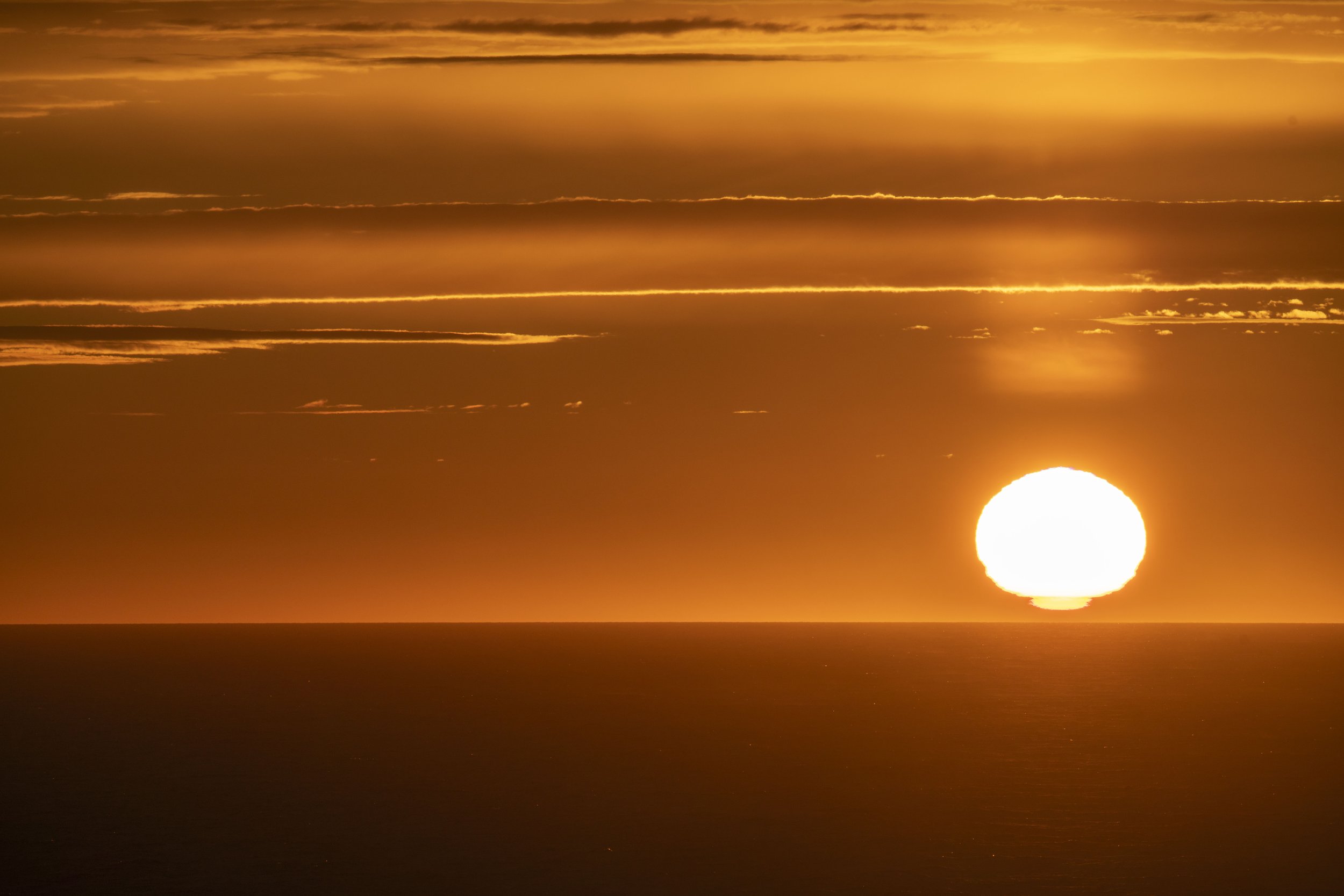 An orange sunset over the ocean.