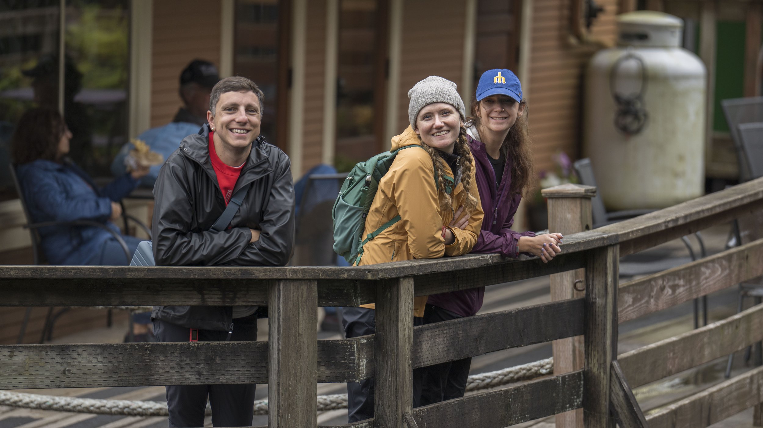 Ian, Kelly, and Ari on a deck.