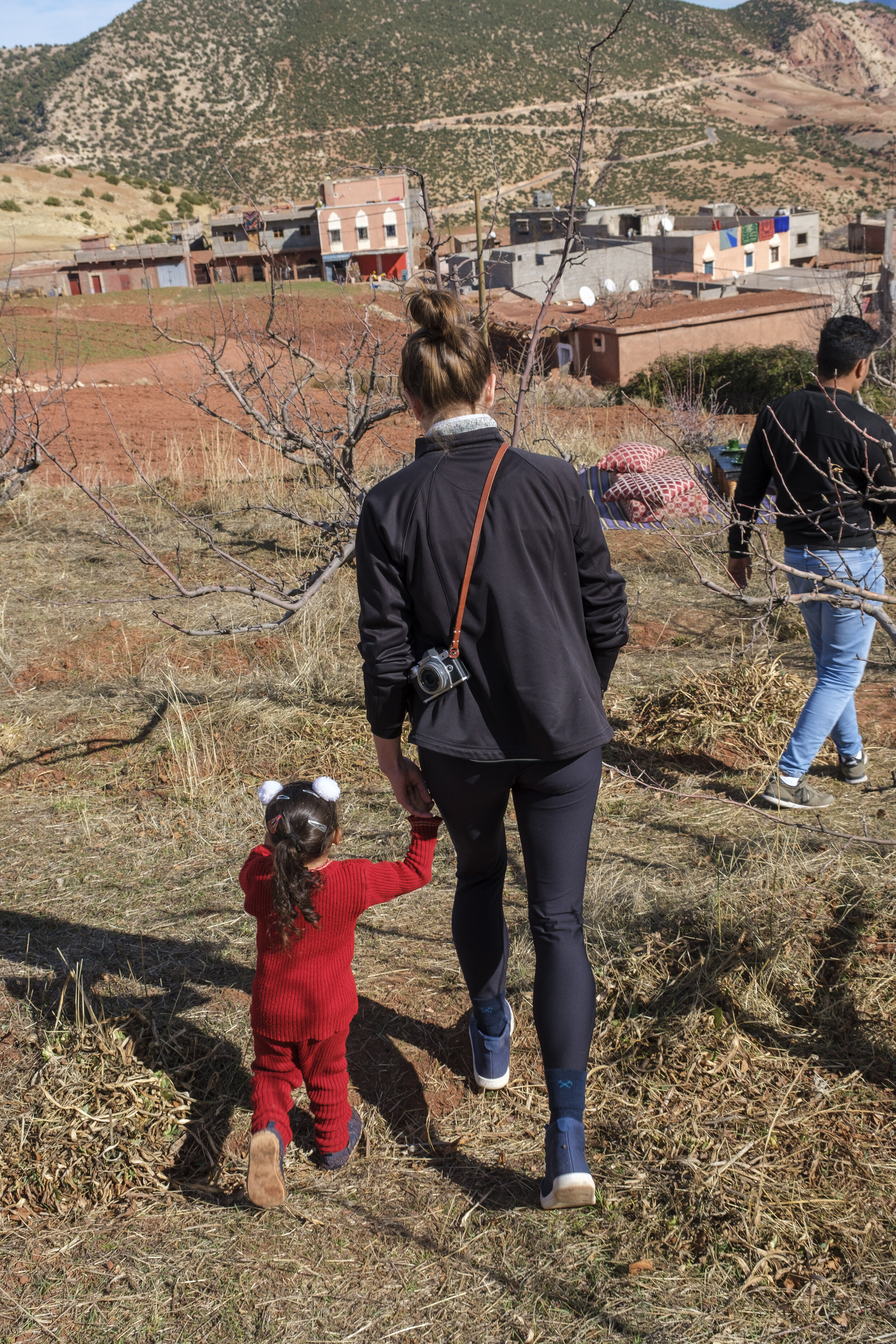 Ally’s new friend helps her down the hill in the orchard (Photo/Jason Rafal) 
