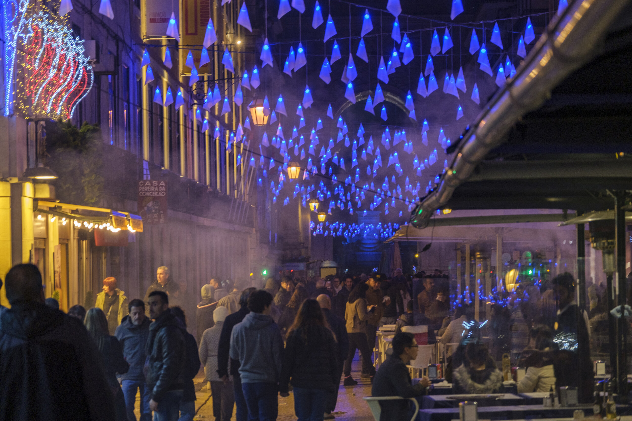  Color-changing lights above a busy street filled with smoke from street food (Photo/Jason Rafal) 