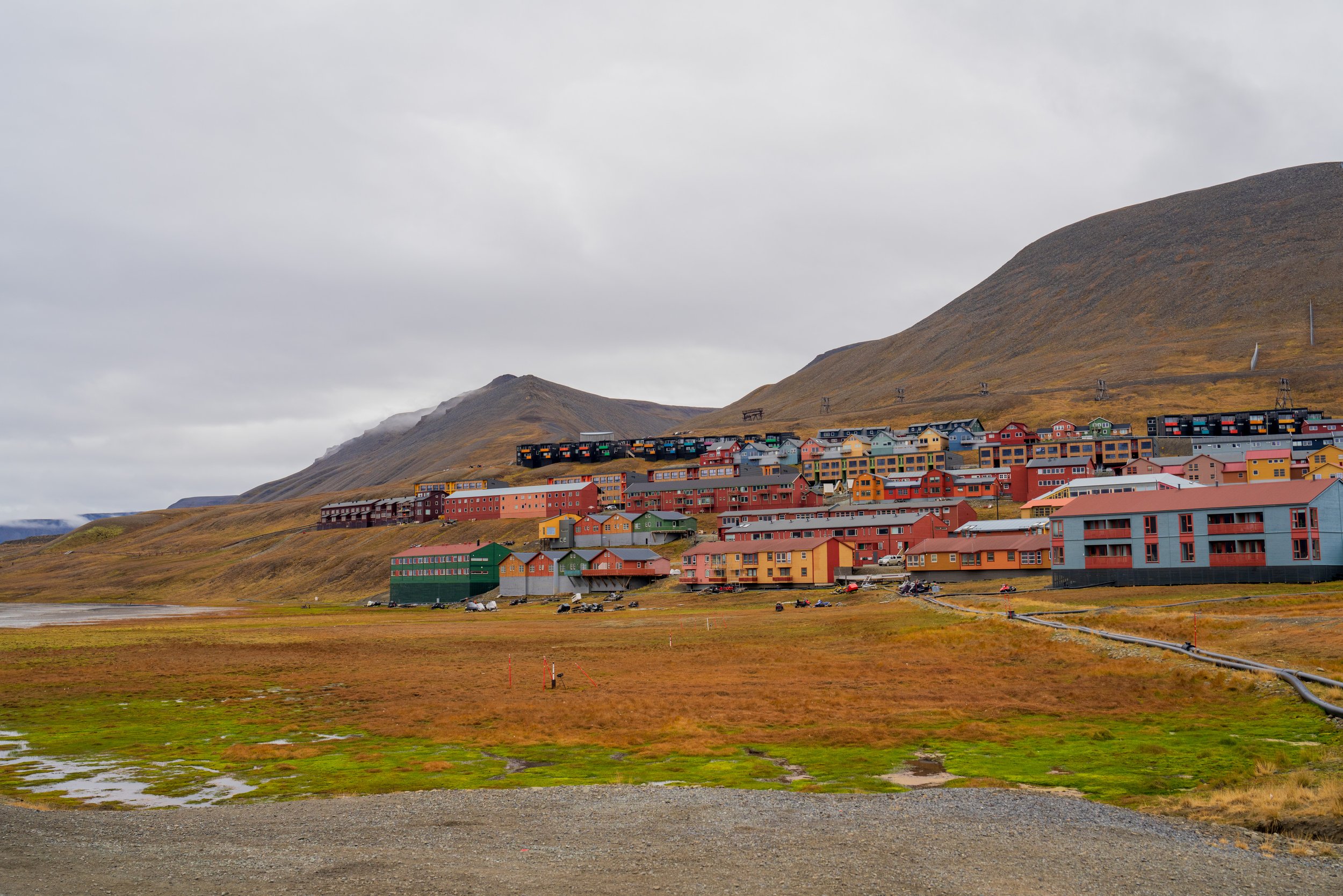  Colorful houses of Longyearbyen with snowmobiles in a row in front (photo/Jason Rafal) 