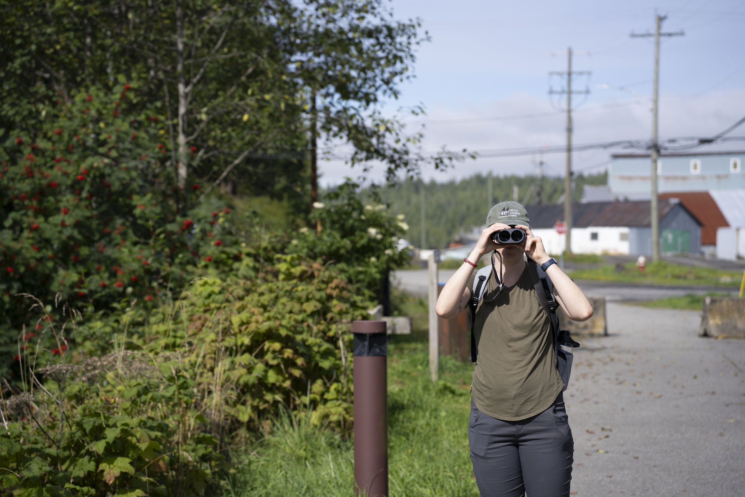 Nicole looking through binoculars at the camera.