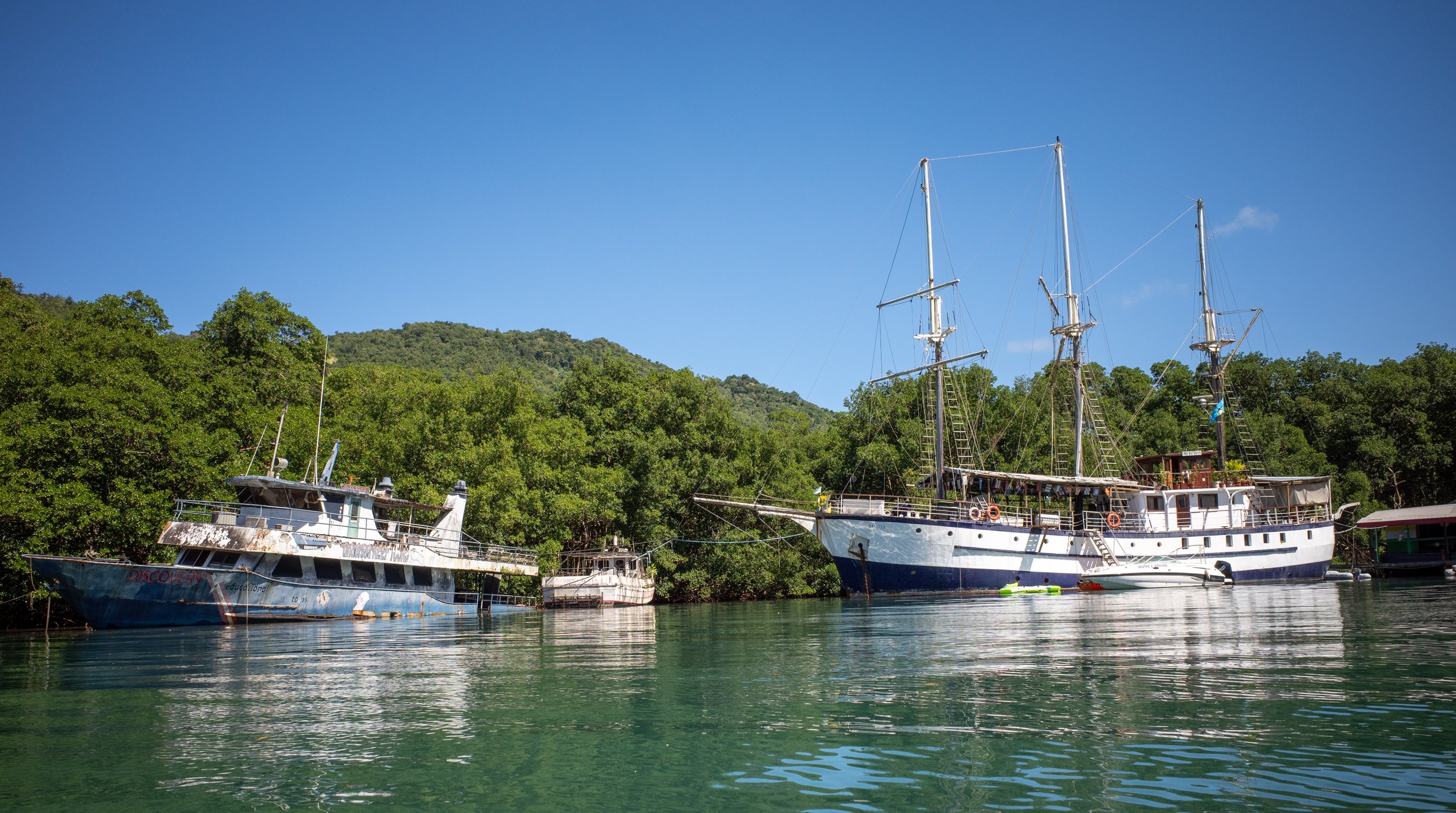 Some of the ships, some floating better than others, in Marigot Bay (photo/Jason Rafal)