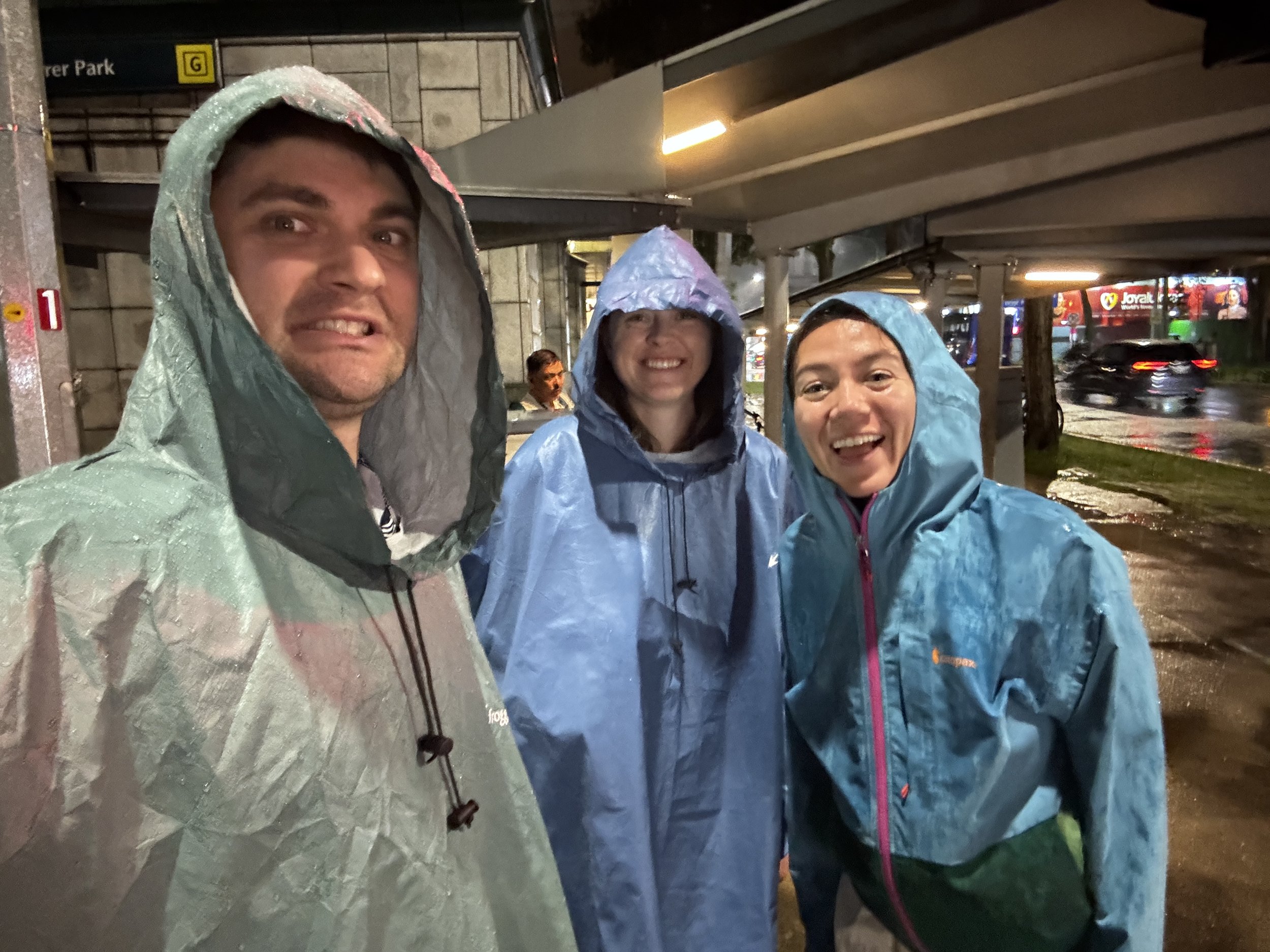 Jason, Nicole, and Bella in rain jackets.
