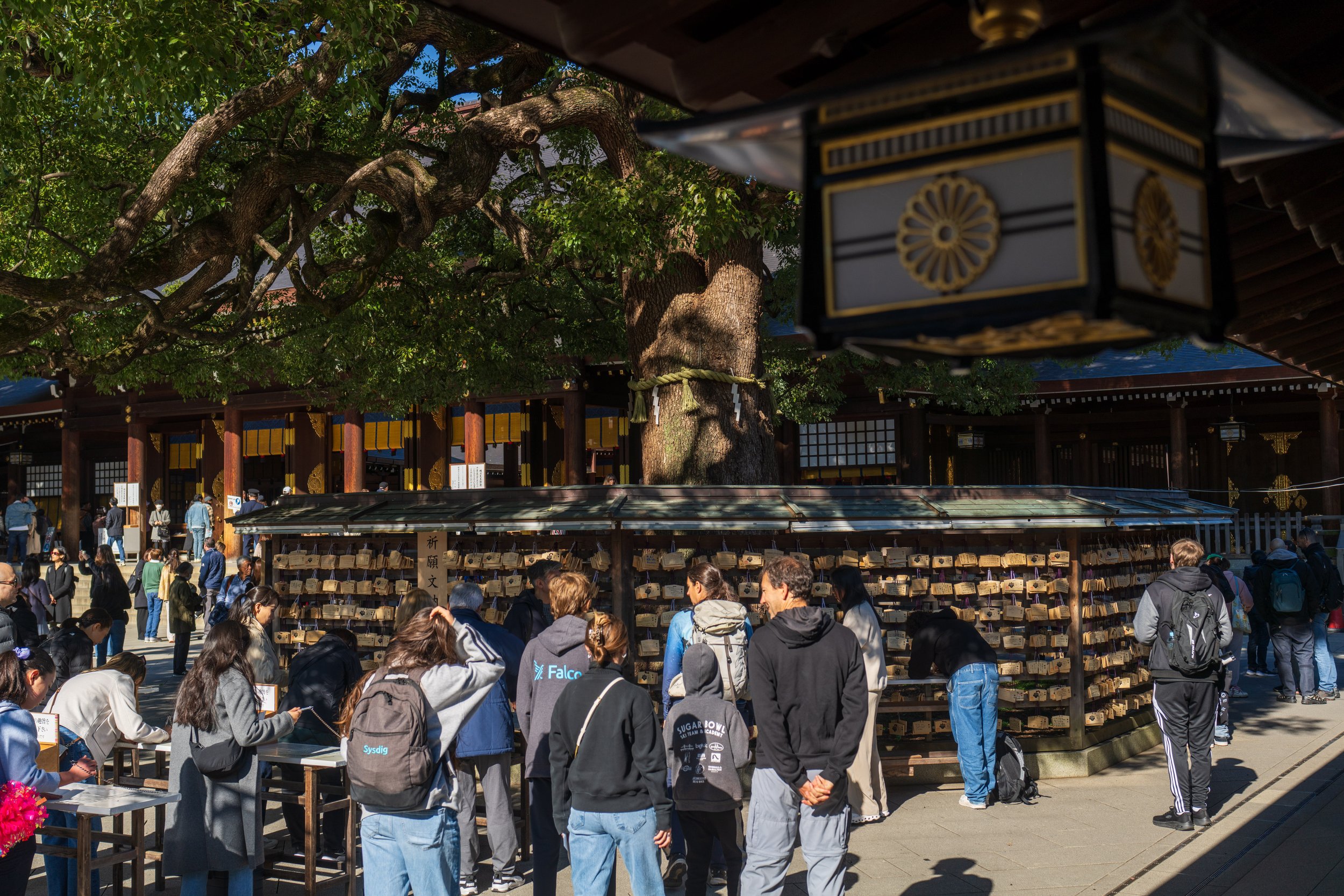  People writing prayers on small wooden plaques called ema (photo/Jason Rafal) 