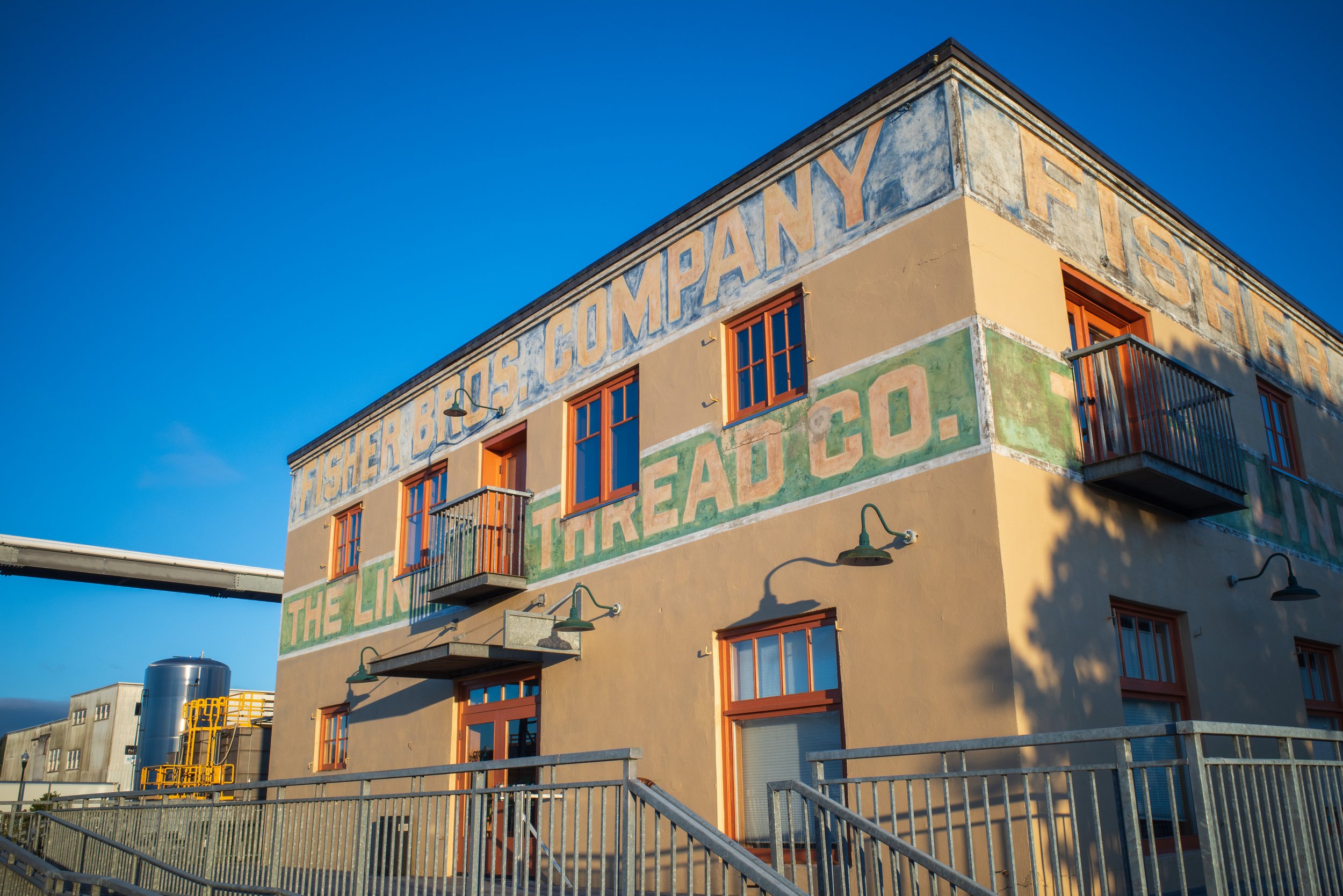 A yellow building against a bright blue sky.